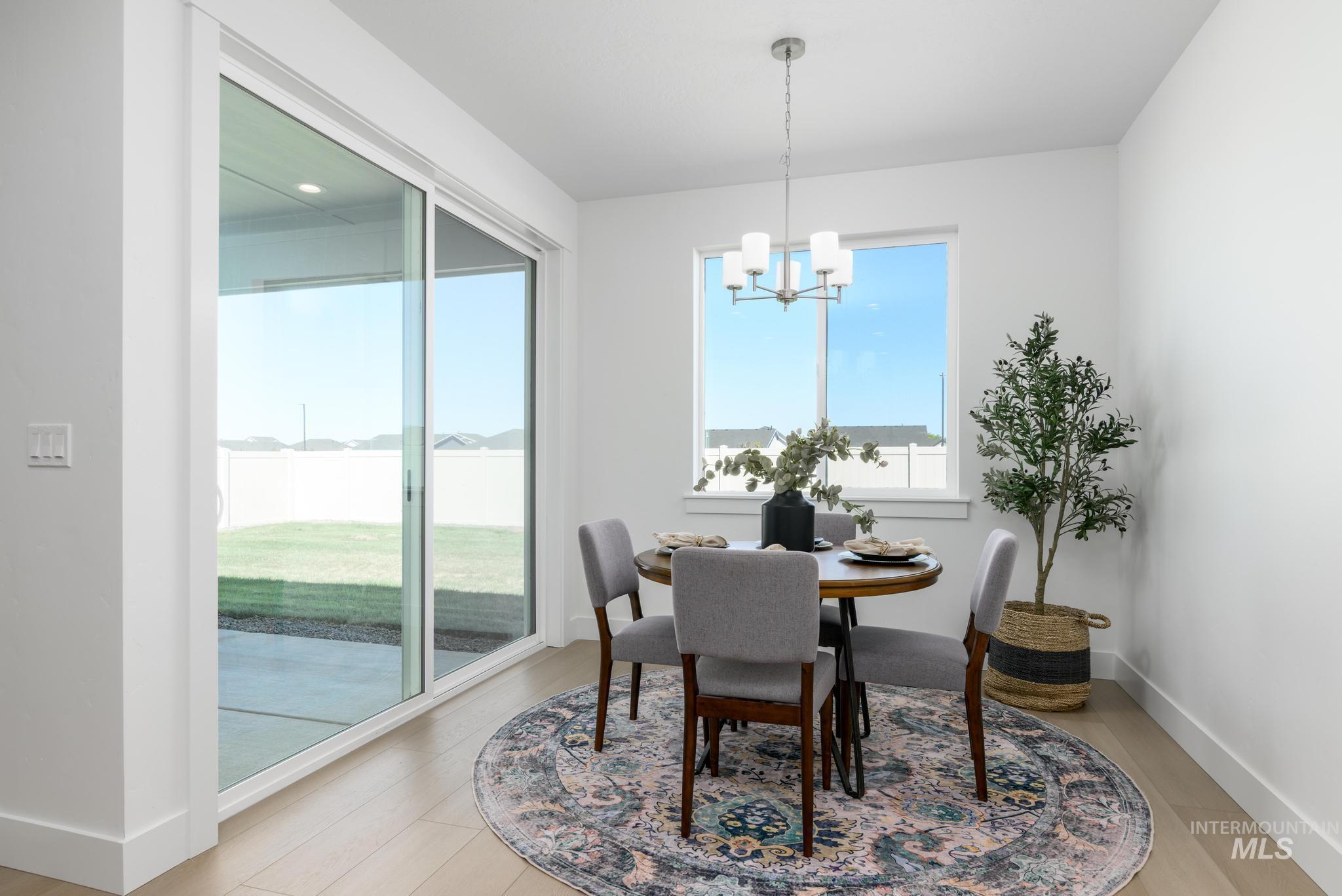 Dining area with a chandelier and light wood-style flooring