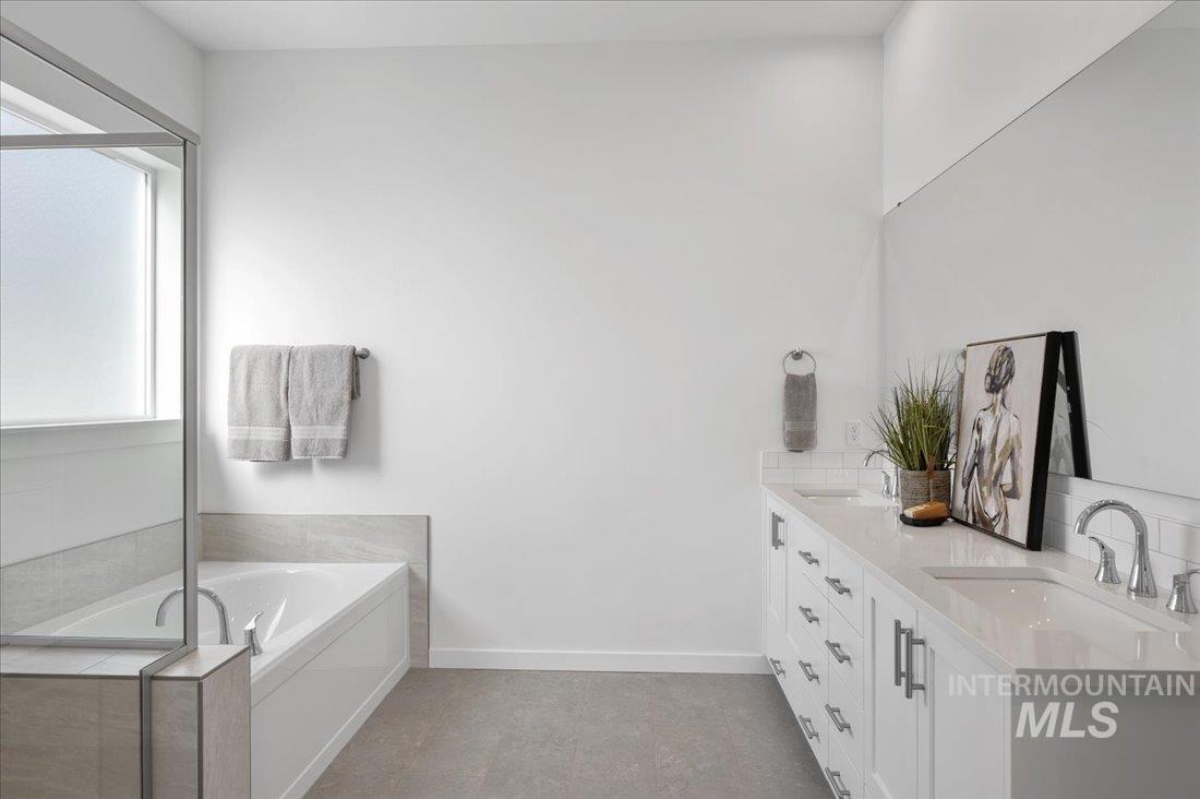 Full bathroom featuring a garden tub and double vanity