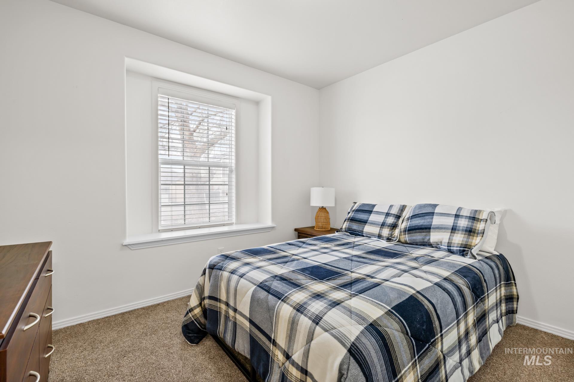 Carpeted bedroom featuring baseboards