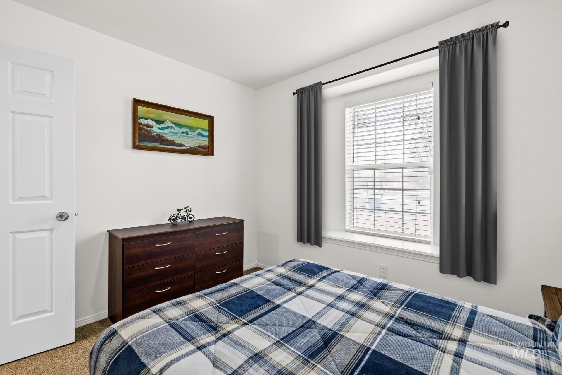 Bedroom featuring carpet floors and baseboards