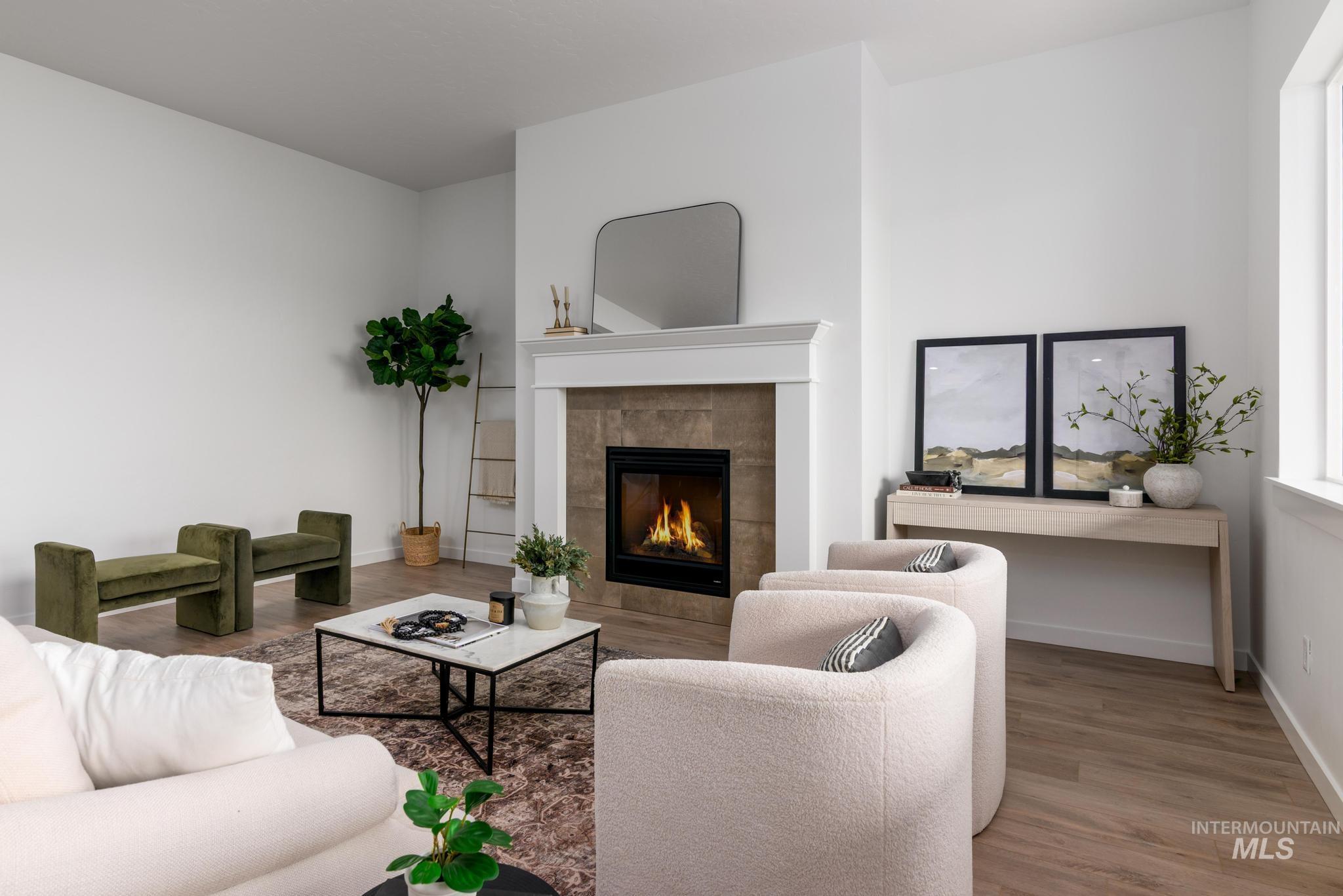 Living area featuring light wood-style flooring and a tile fireplace