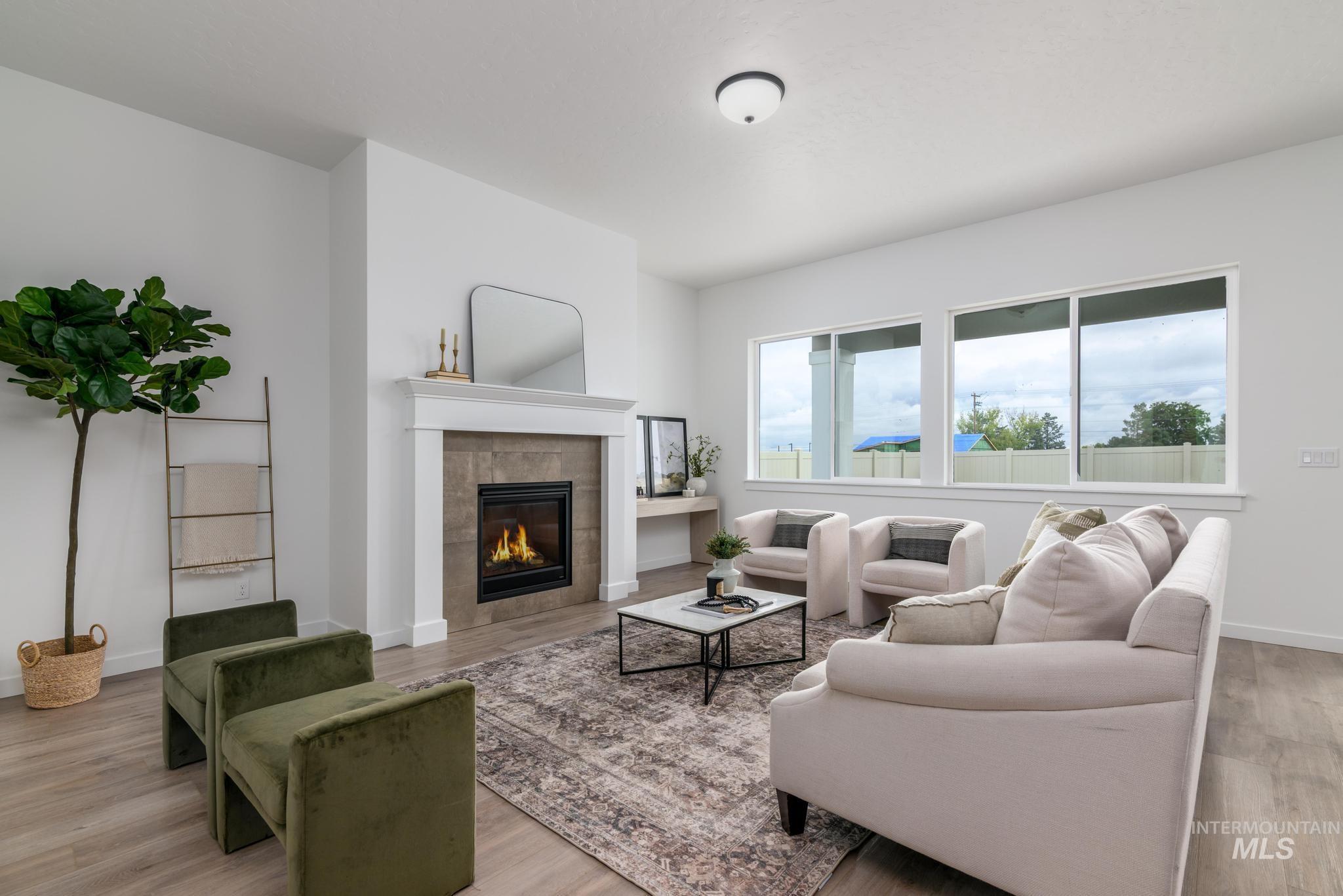Living room with a tiled fireplace and light wood-style flooring