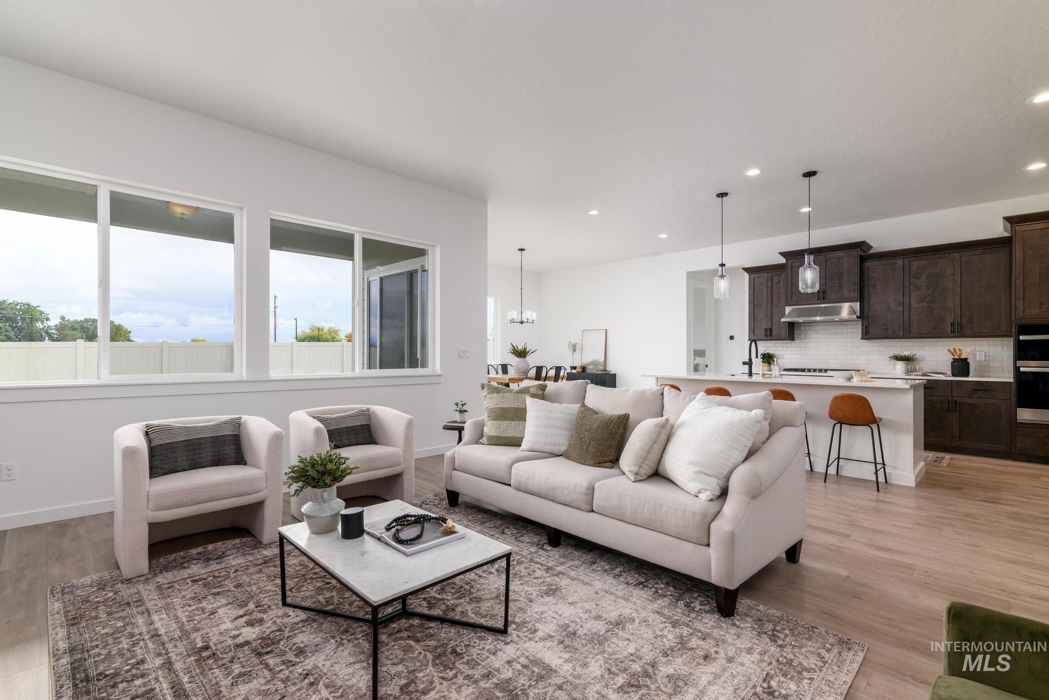 Living area featuring recessed lighting, light wood finished floors, and a chandelier