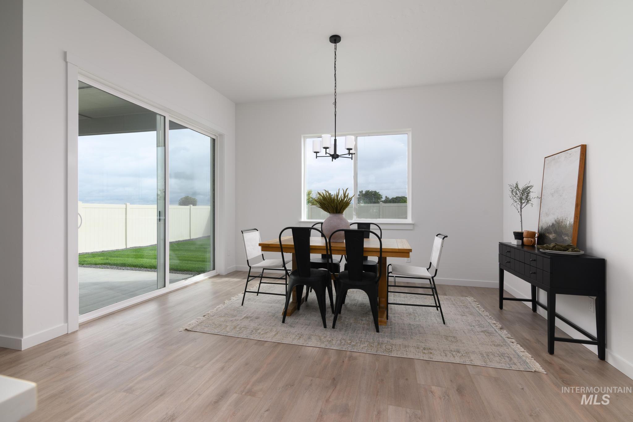 Dining room featuring a chandelier and light wood finished floors