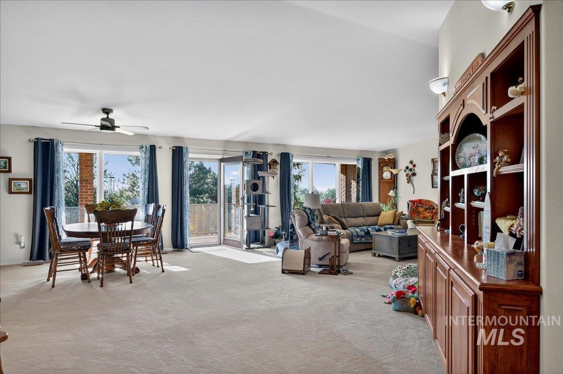 Interior space with light colored carpet and ceiling fan