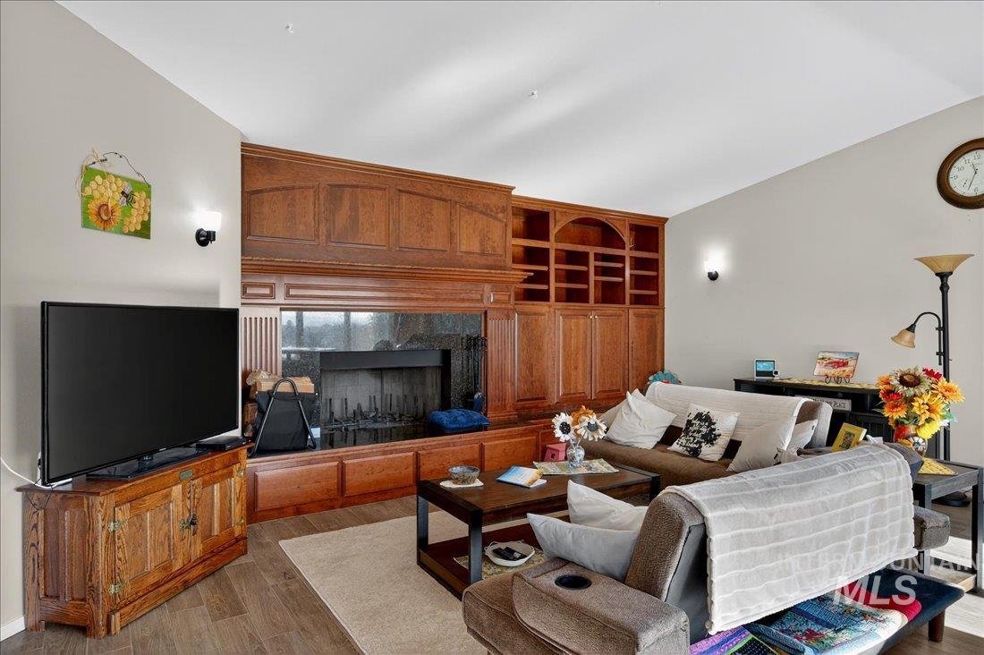 Living room with wood finished floors and a fireplace