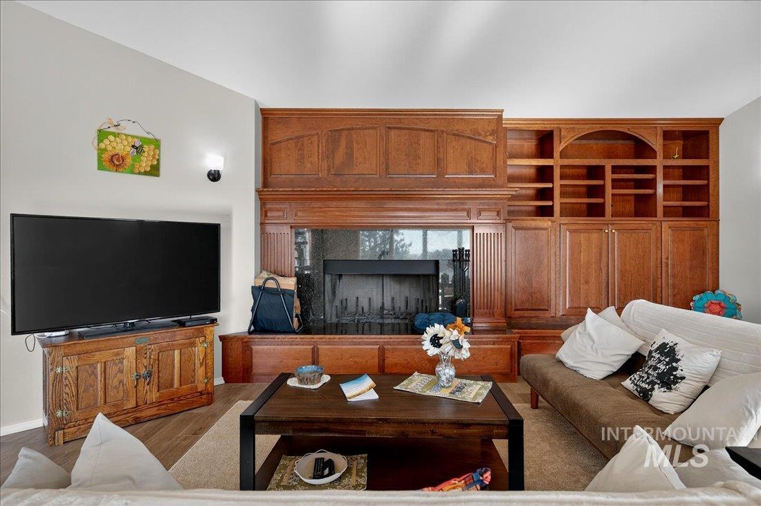 Living area with wood finished floors and a fireplace