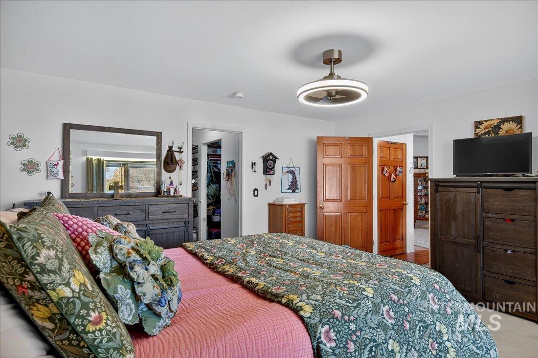Bedroom featuring a walk in closet and ceiling fan