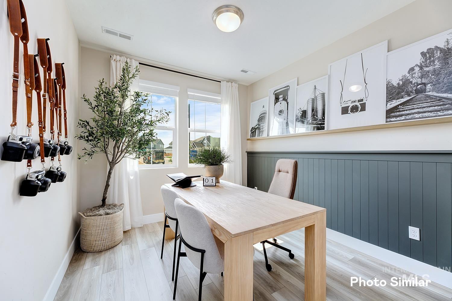 Dining area with light wood finished floors and an office area