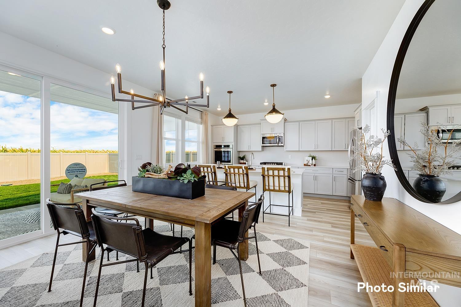 Dining room featuring light wood-type flooring, a chandelier, and recessed lighting