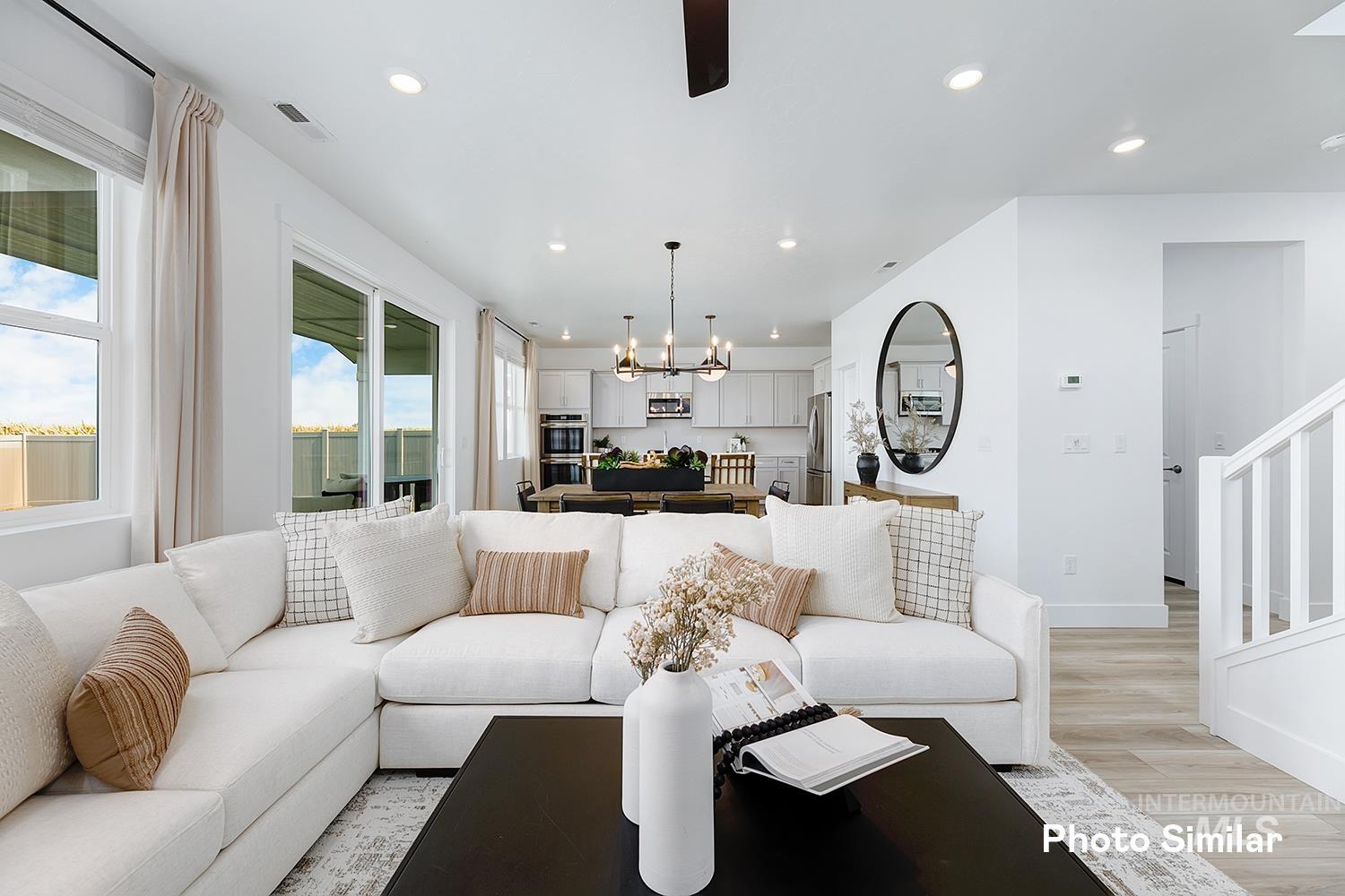 Living area featuring light wood-style flooring, a chandelier, and recessed lighting