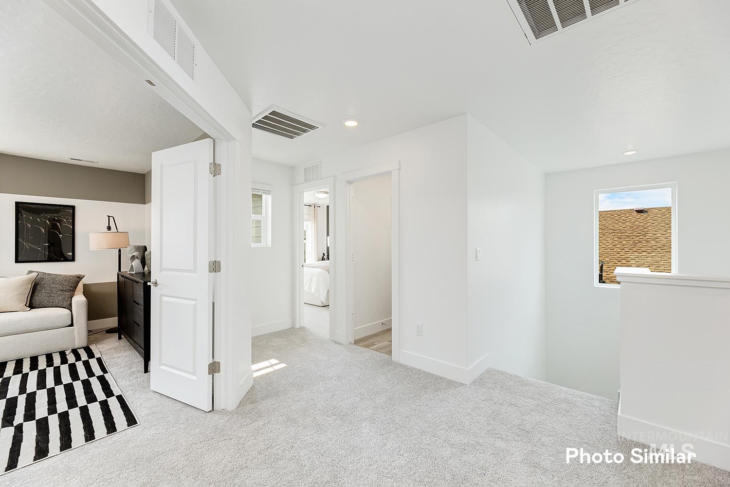 Corridor with light carpet, an upstairs landing, and recessed lighting
