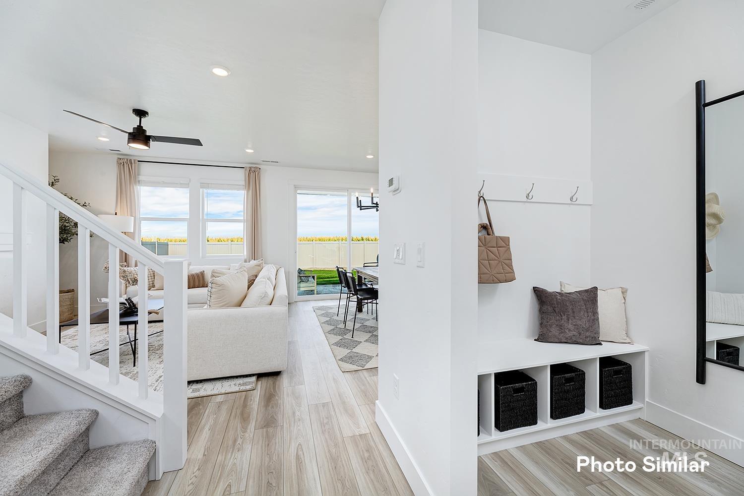 Living area featuring stairs, light wood-style flooring, recessed lighting, and ceiling fan