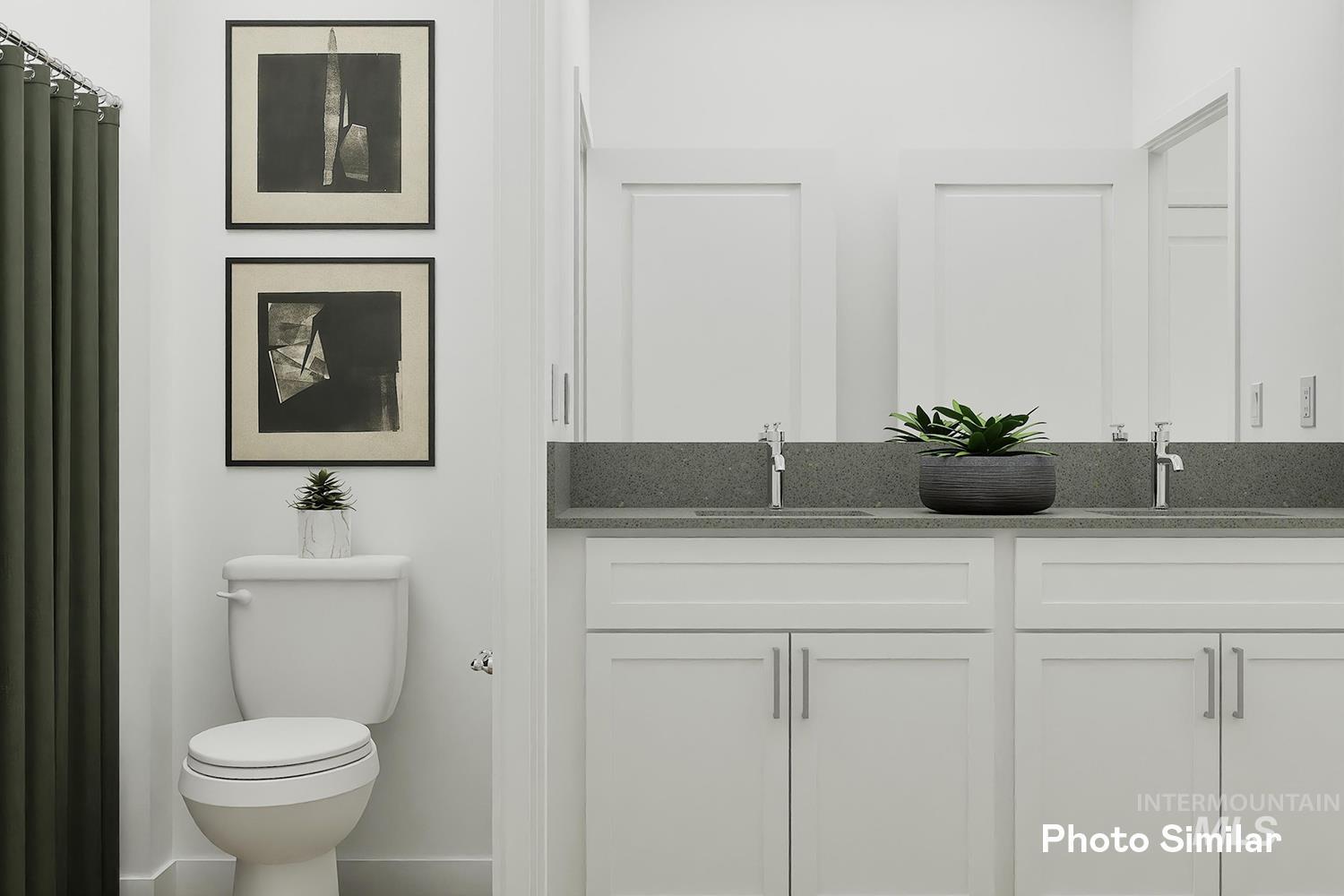 Full bath featuring double vanity and toilet