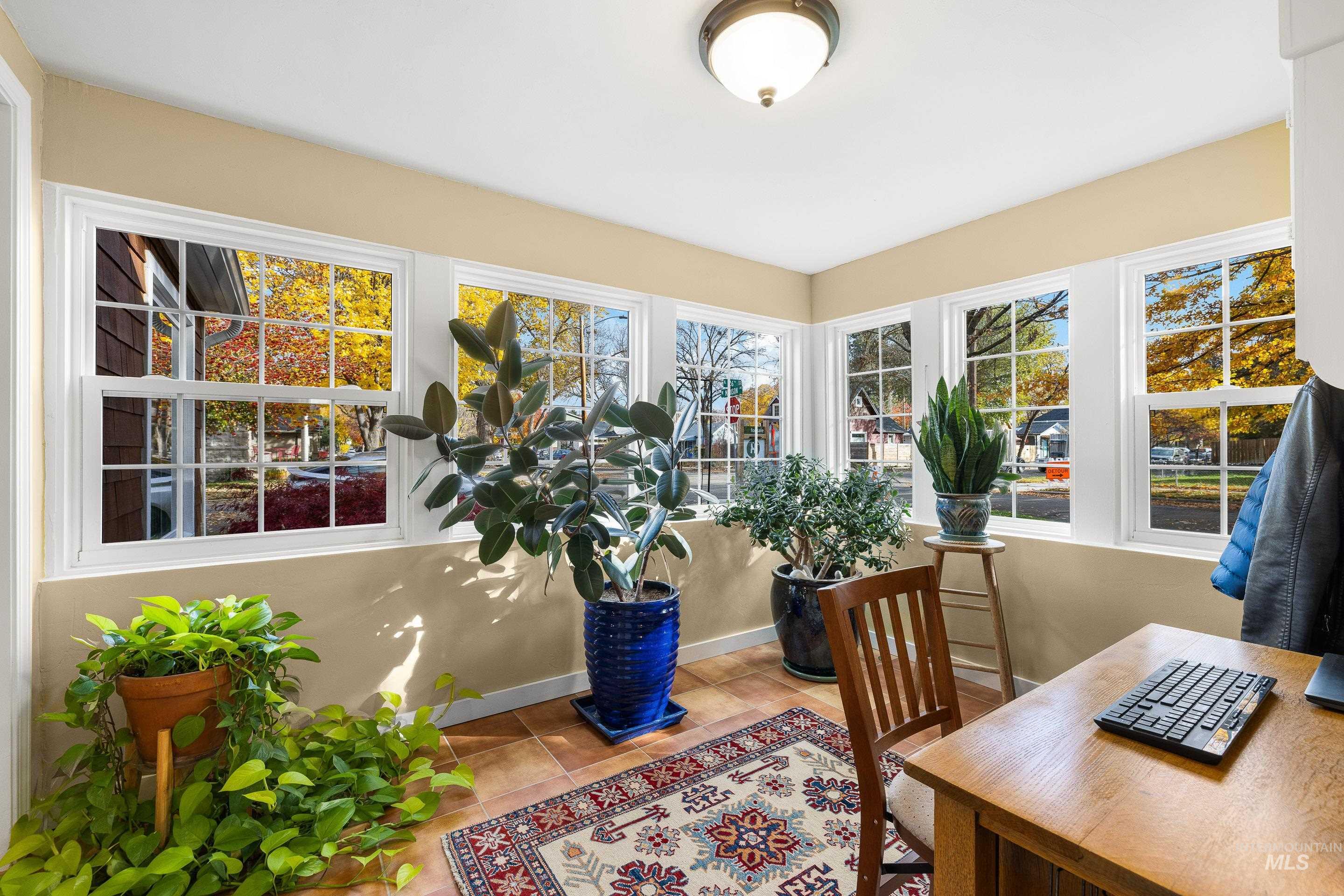 Office area with healthy amount of natural light and light tile patterned floors