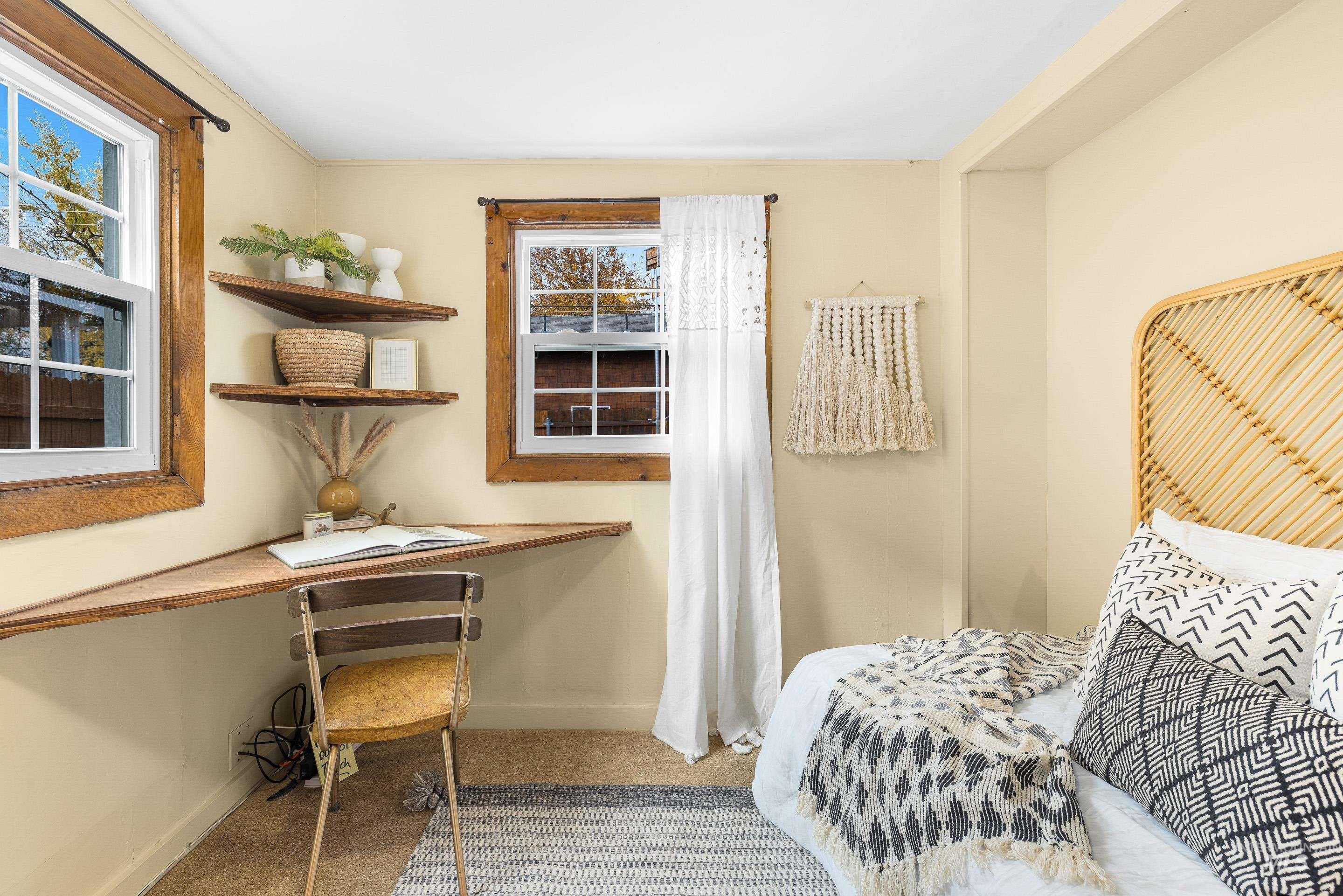Bedroom with built in study area and light tile patterned floors