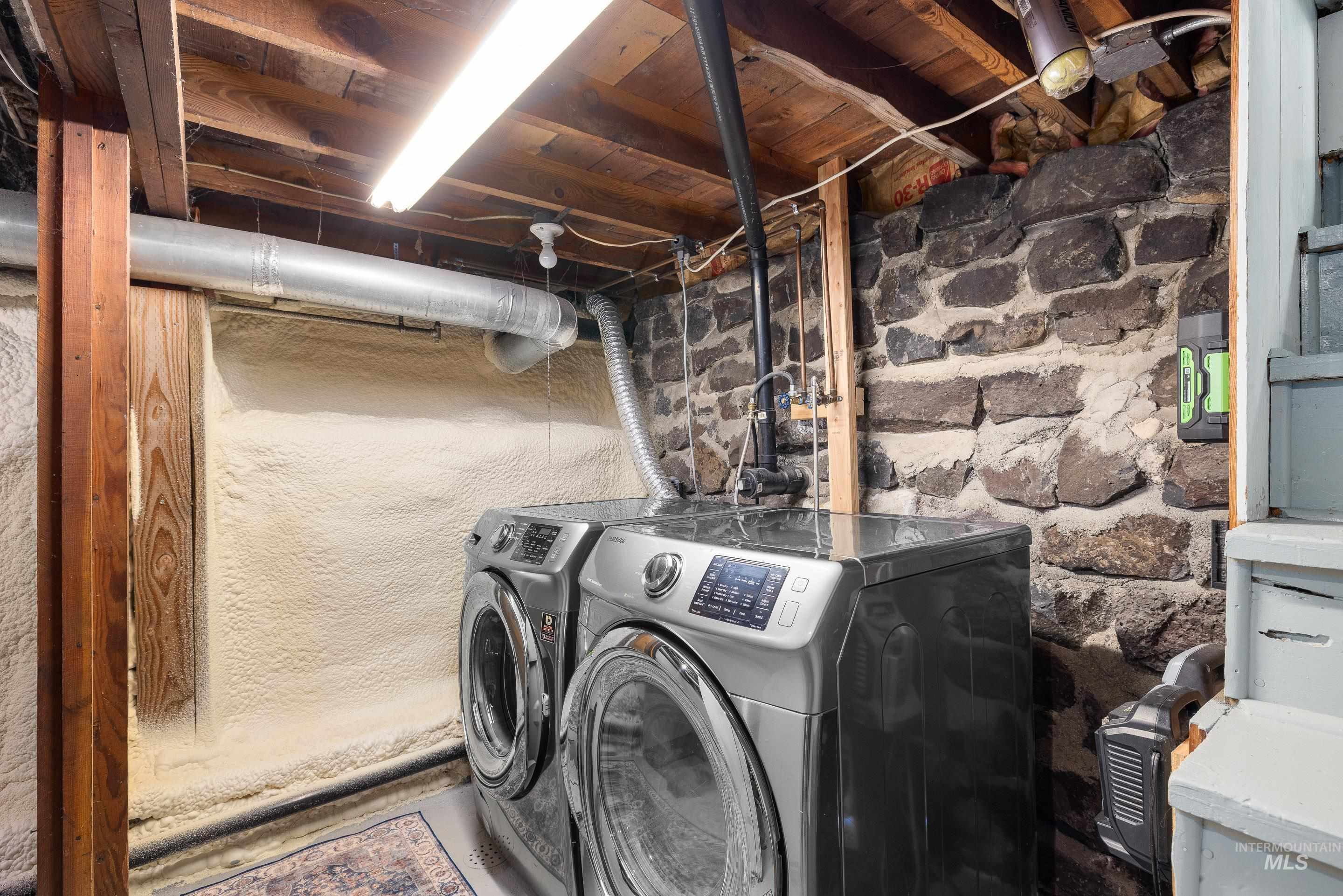 Laundry room with washing machine and clothes dryer