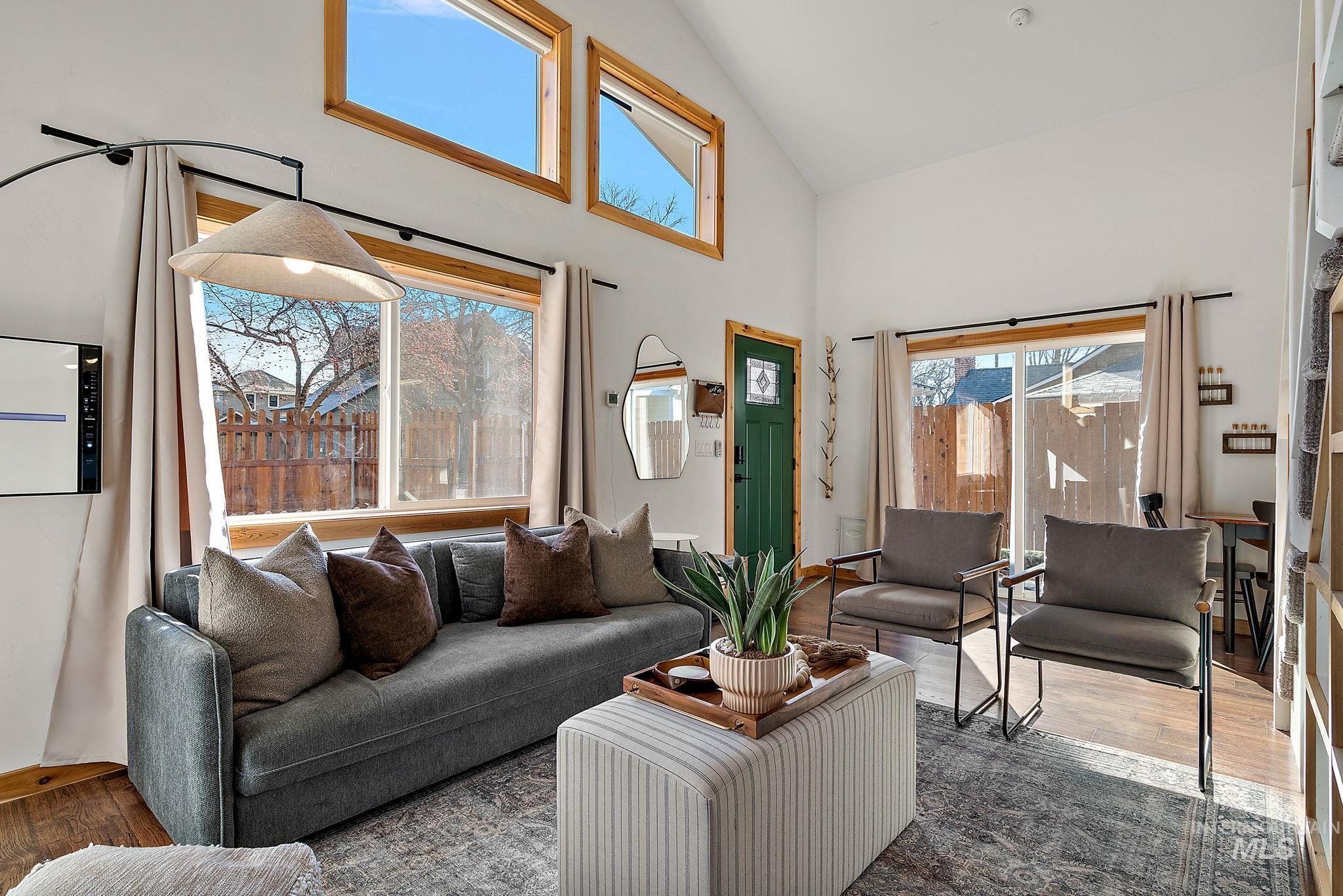 Living area featuring wood finished floors and high vaulted ceiling