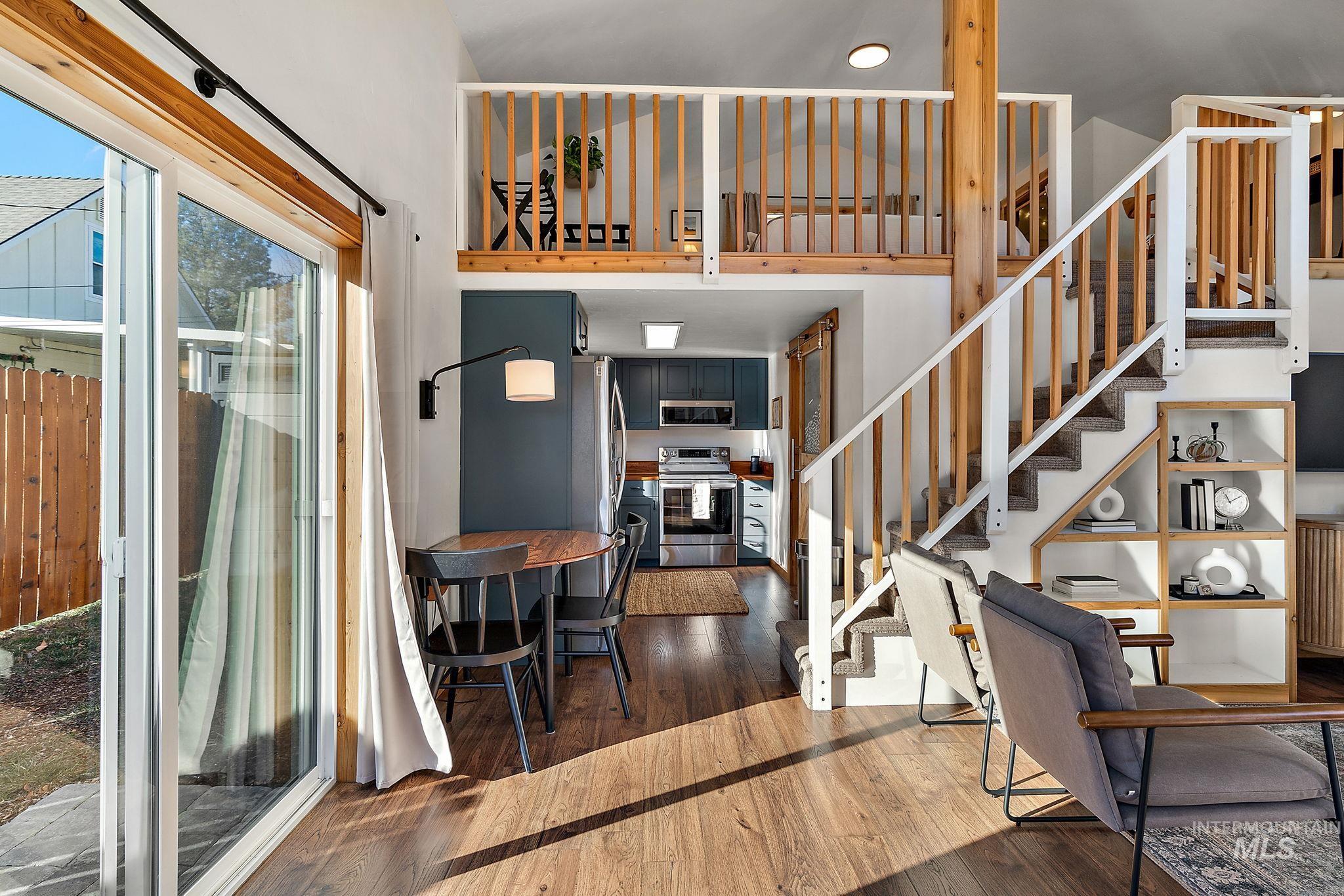 Staircase featuring hardwood / wood-style flooring