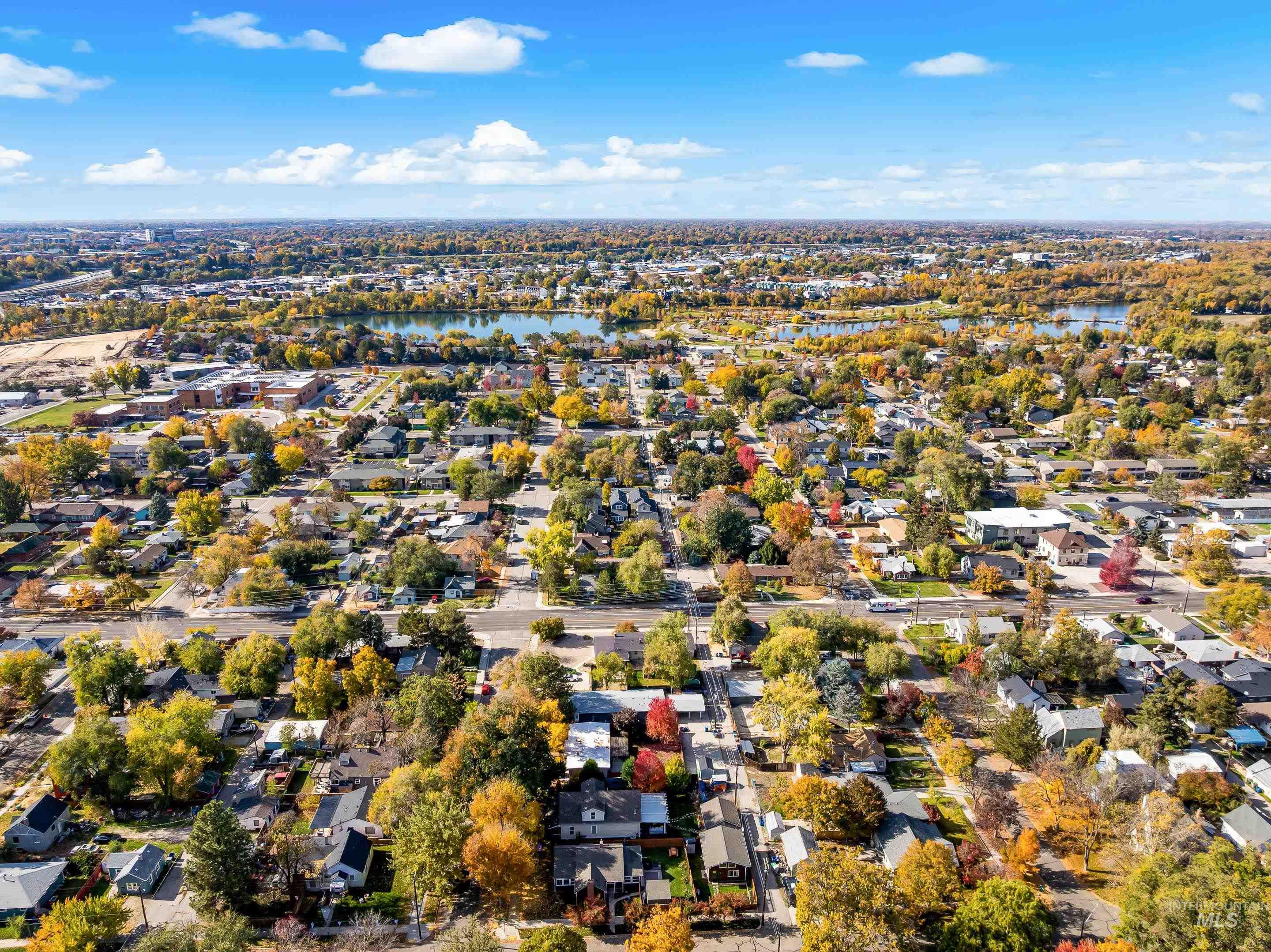 Aerial view of property's location featuring a large body of water and nearby suburban area