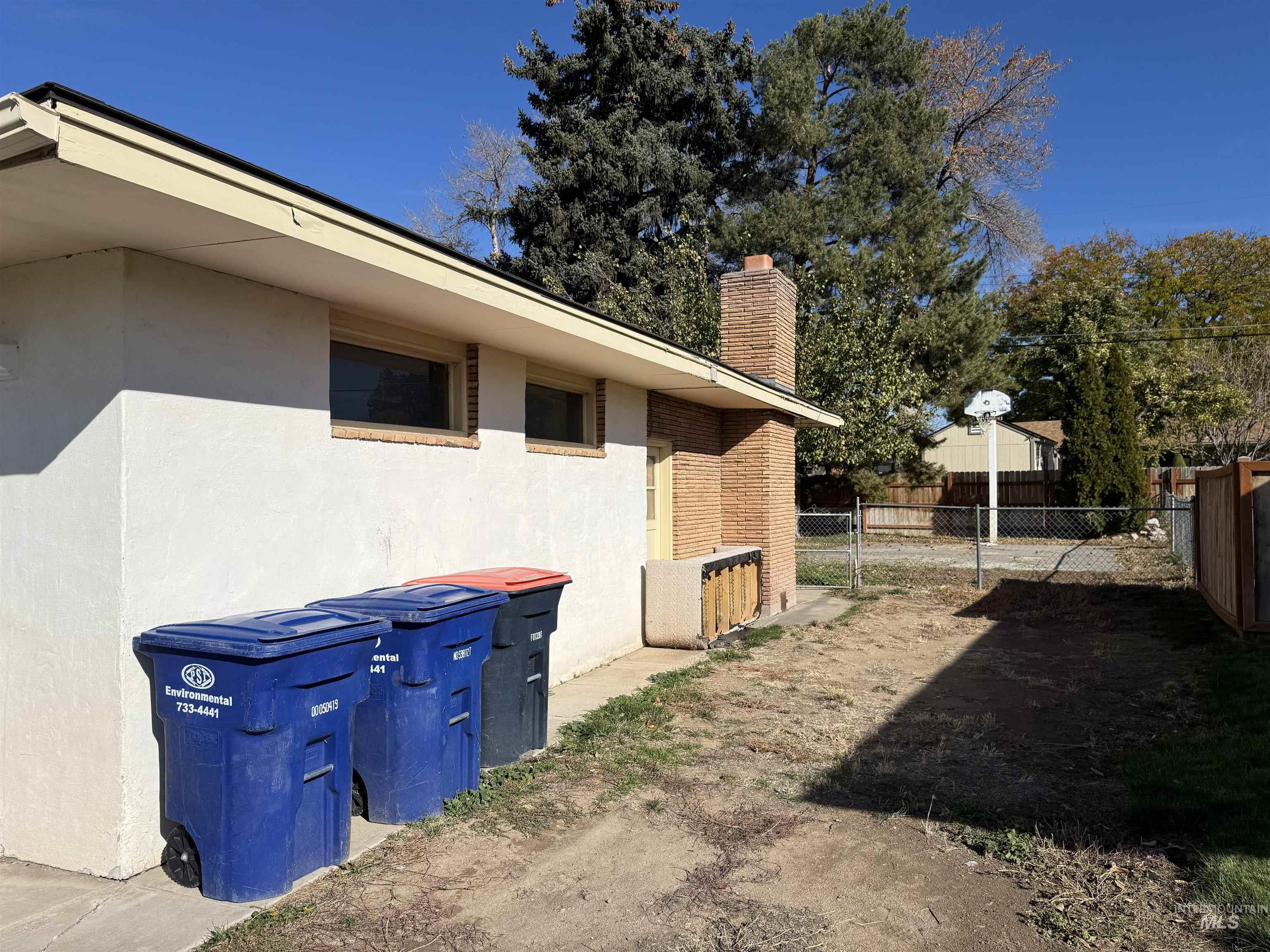 View of property exterior featuring a chimney and stucco siding