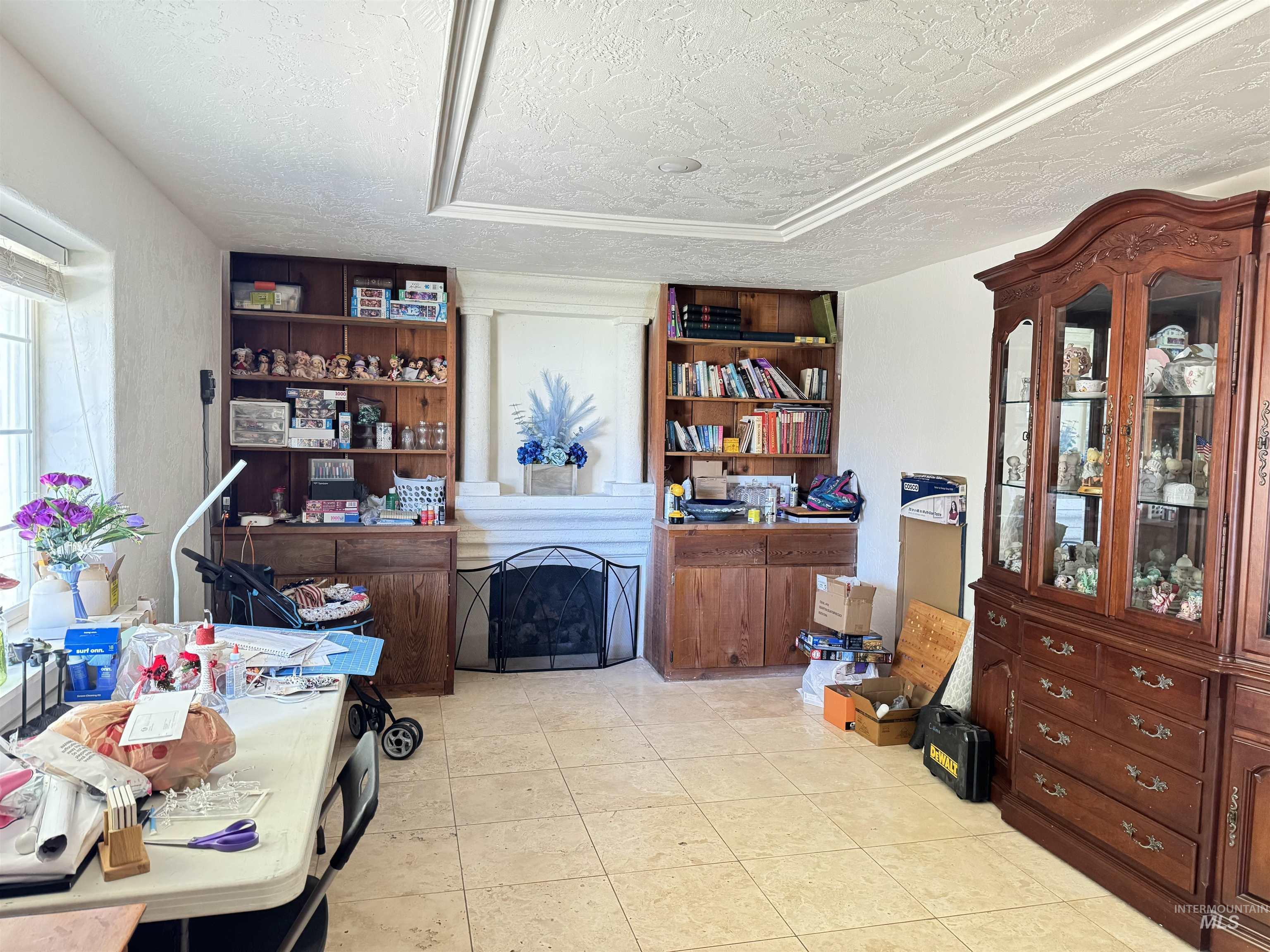Office with a textured ceiling and light tile patterned floors