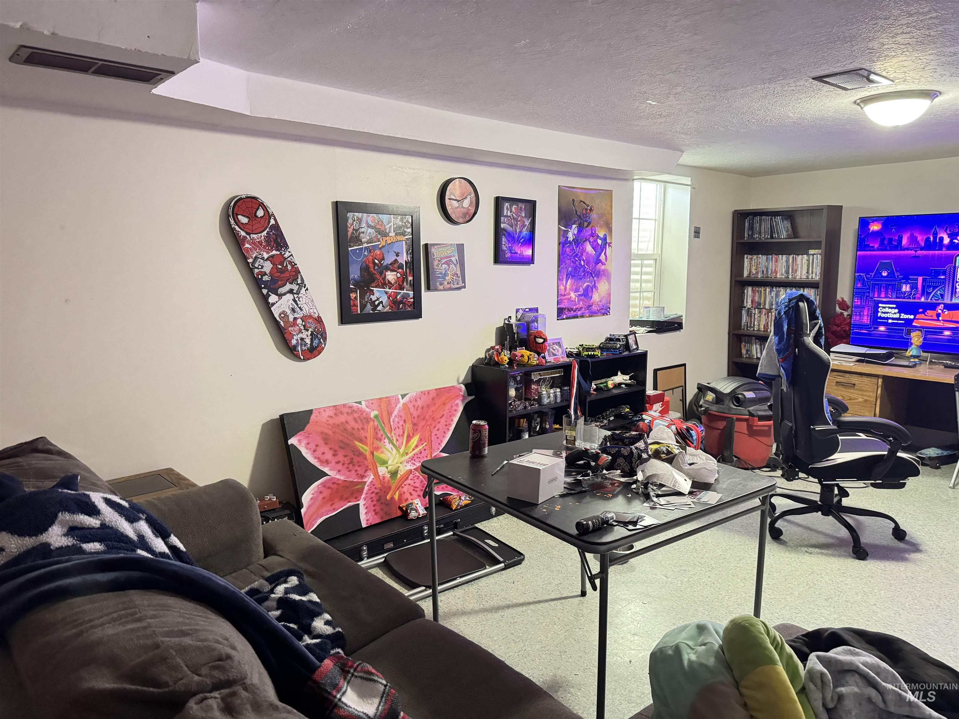Office featuring a textured ceiling and carpet