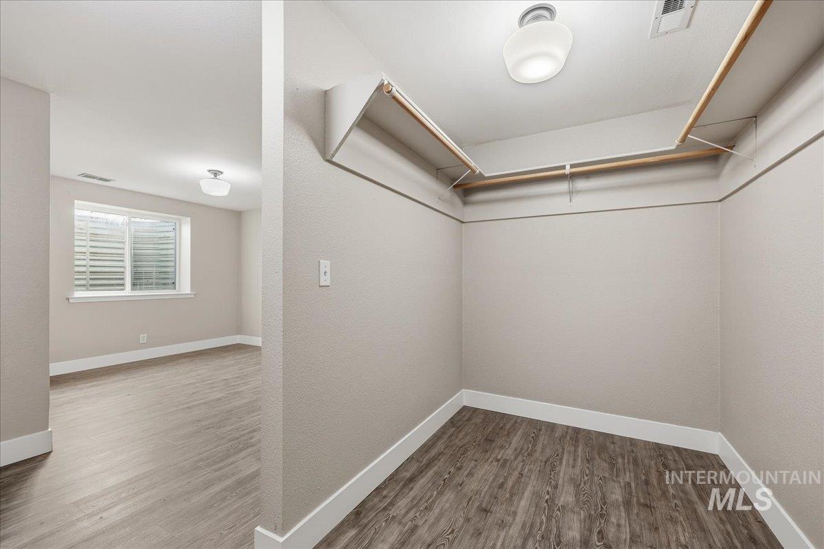 Walk in closet featuring light wood-style flooring