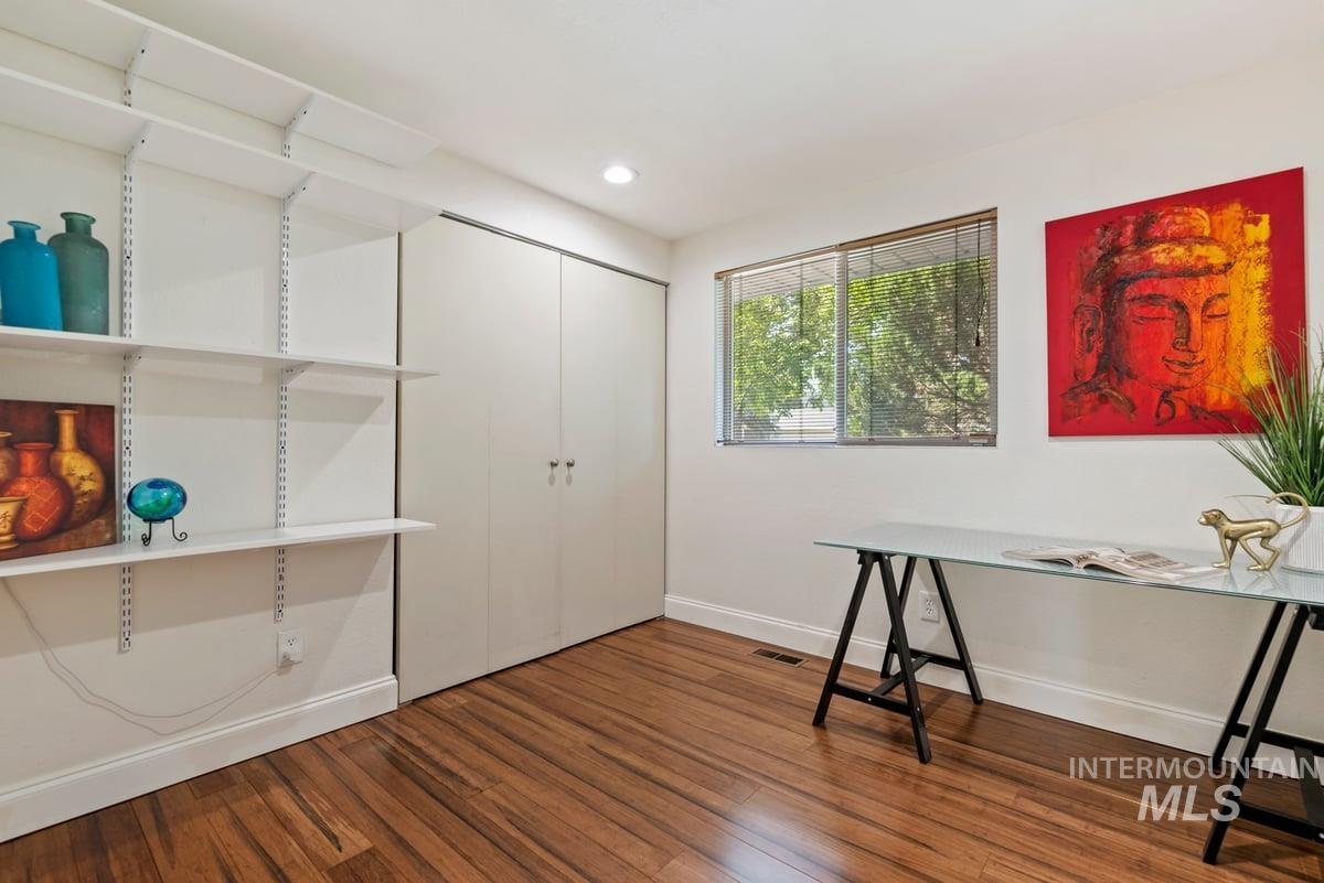 Unfurnished office featuring wood finished floors and recessed lighting