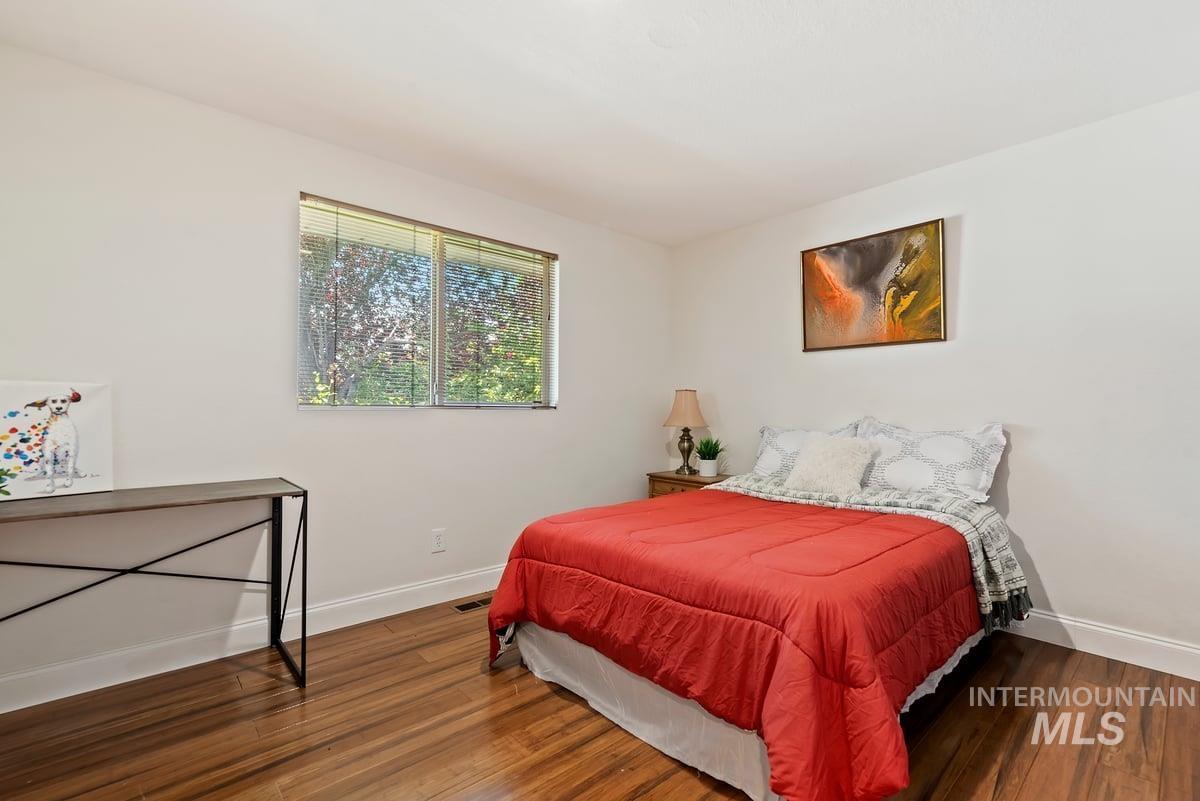 Bedroom with baseboards and wood finished floors