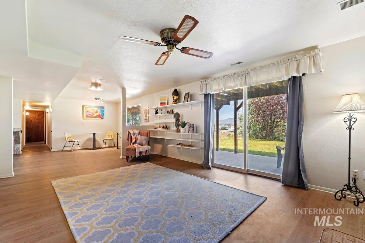 Sitting room with a ceiling fan and wood finished floors