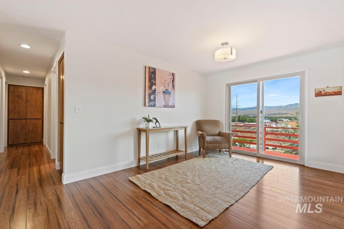 Living area featuring wood finished floors, recessed lighting, and a mountain view