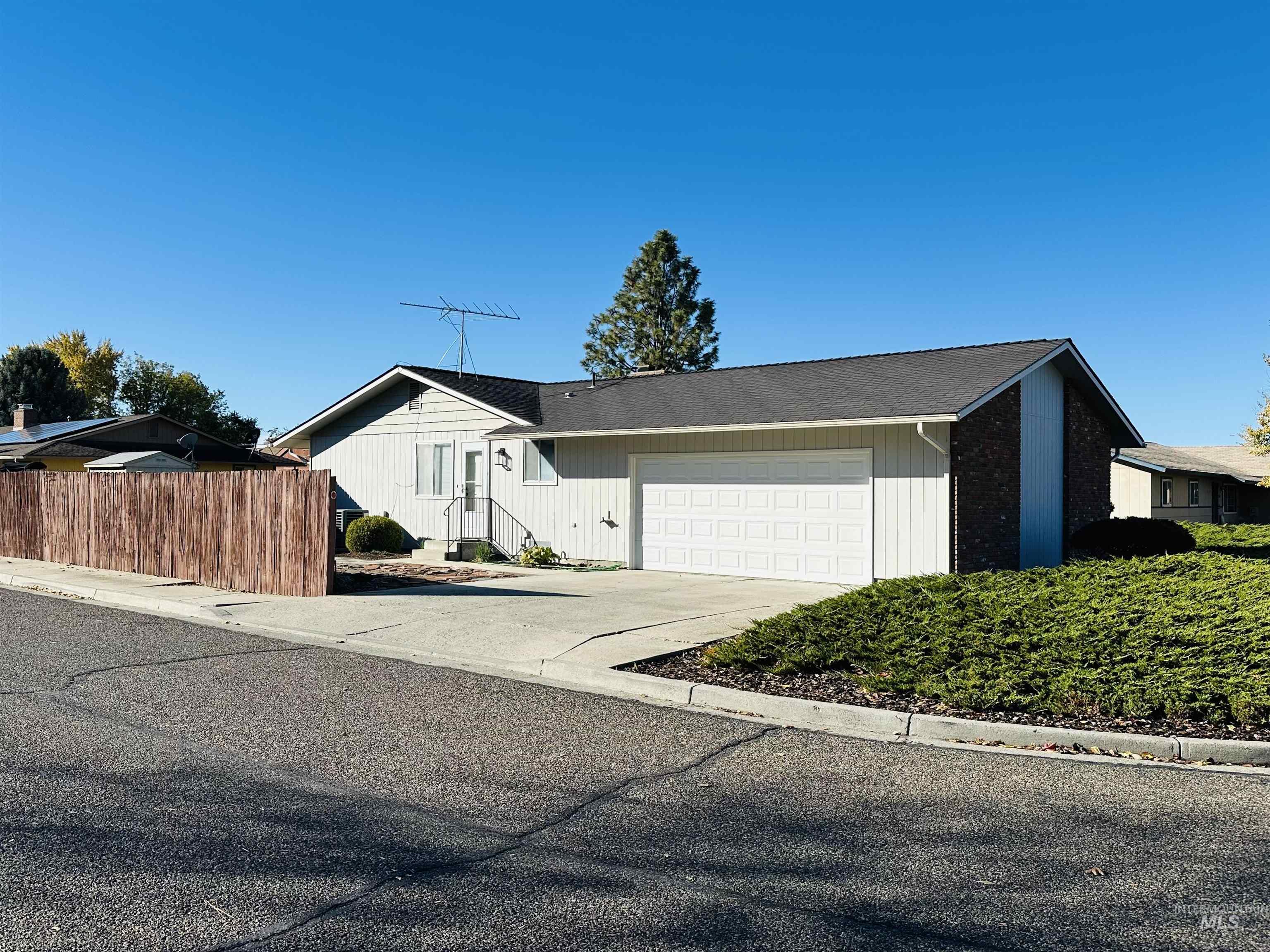 View of home's exterior with concrete driveway, a garage, and roof with shingles