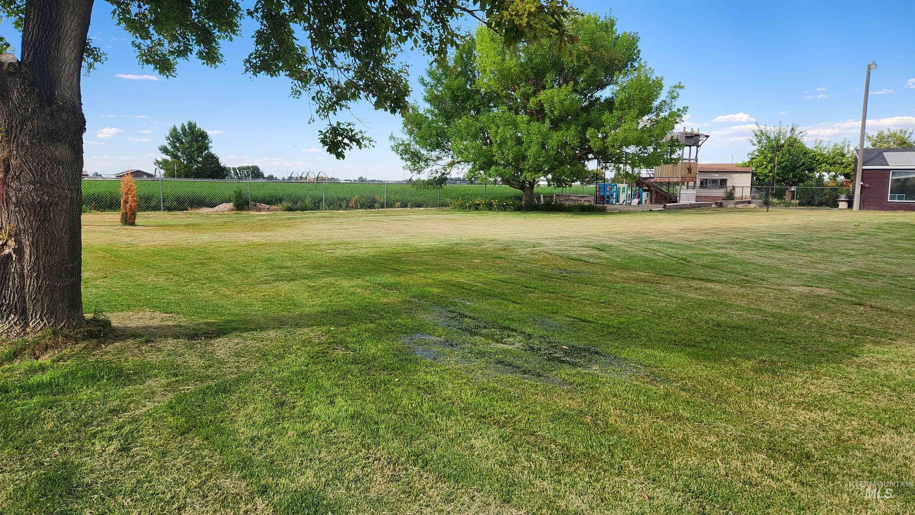View of grassy yard with a deck