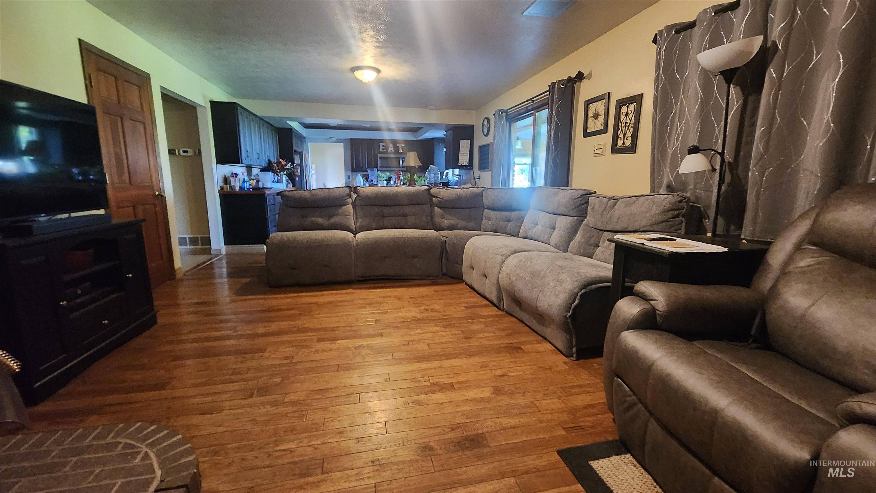 Living area with hardwood / wood-style floors