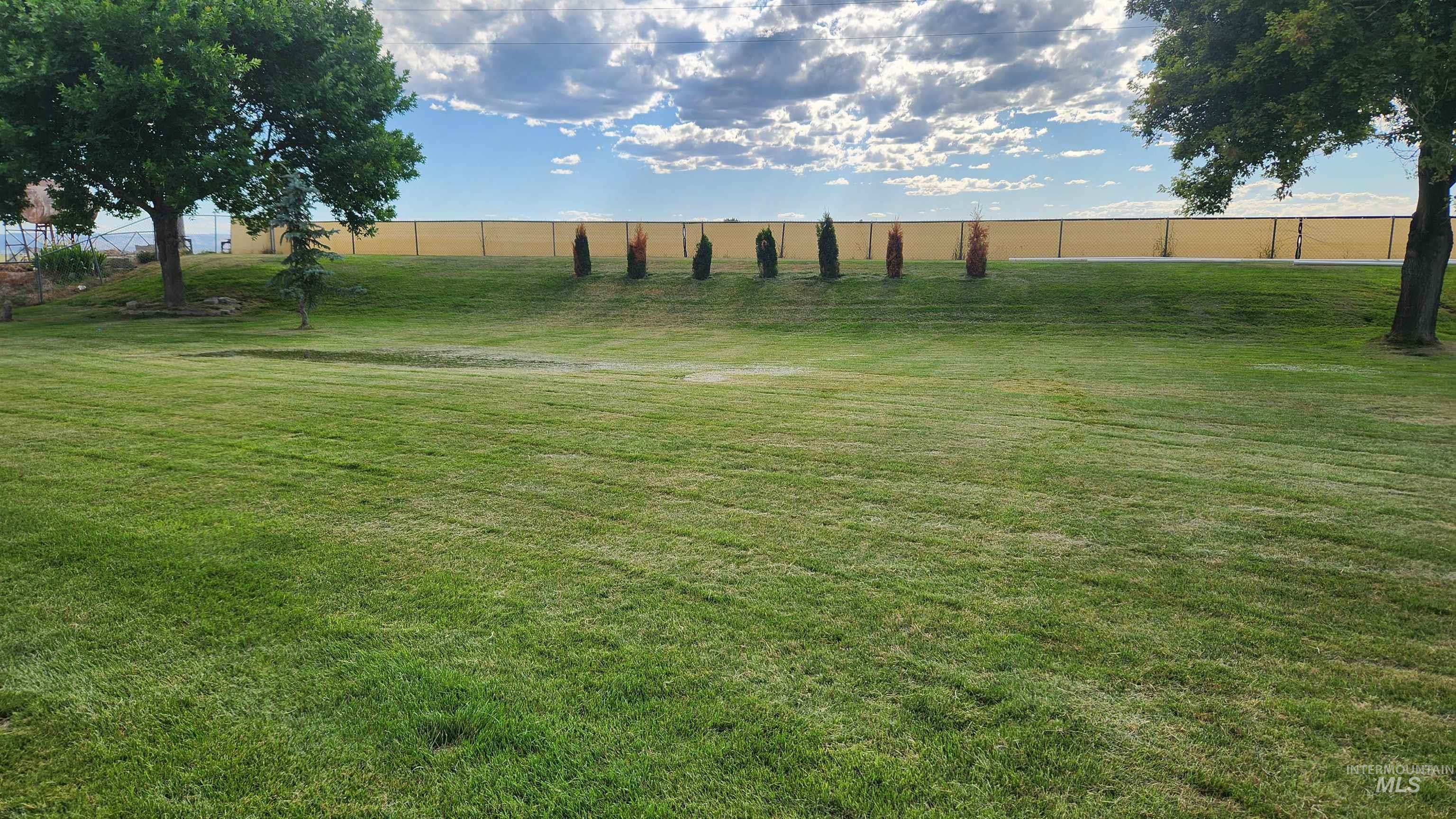 View of yard with a rural view