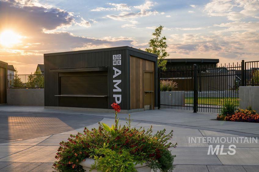 View of outbuilding featuring a garage and a gate