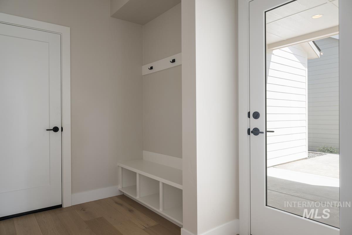 Mudroom with baseboards and wood finished floors