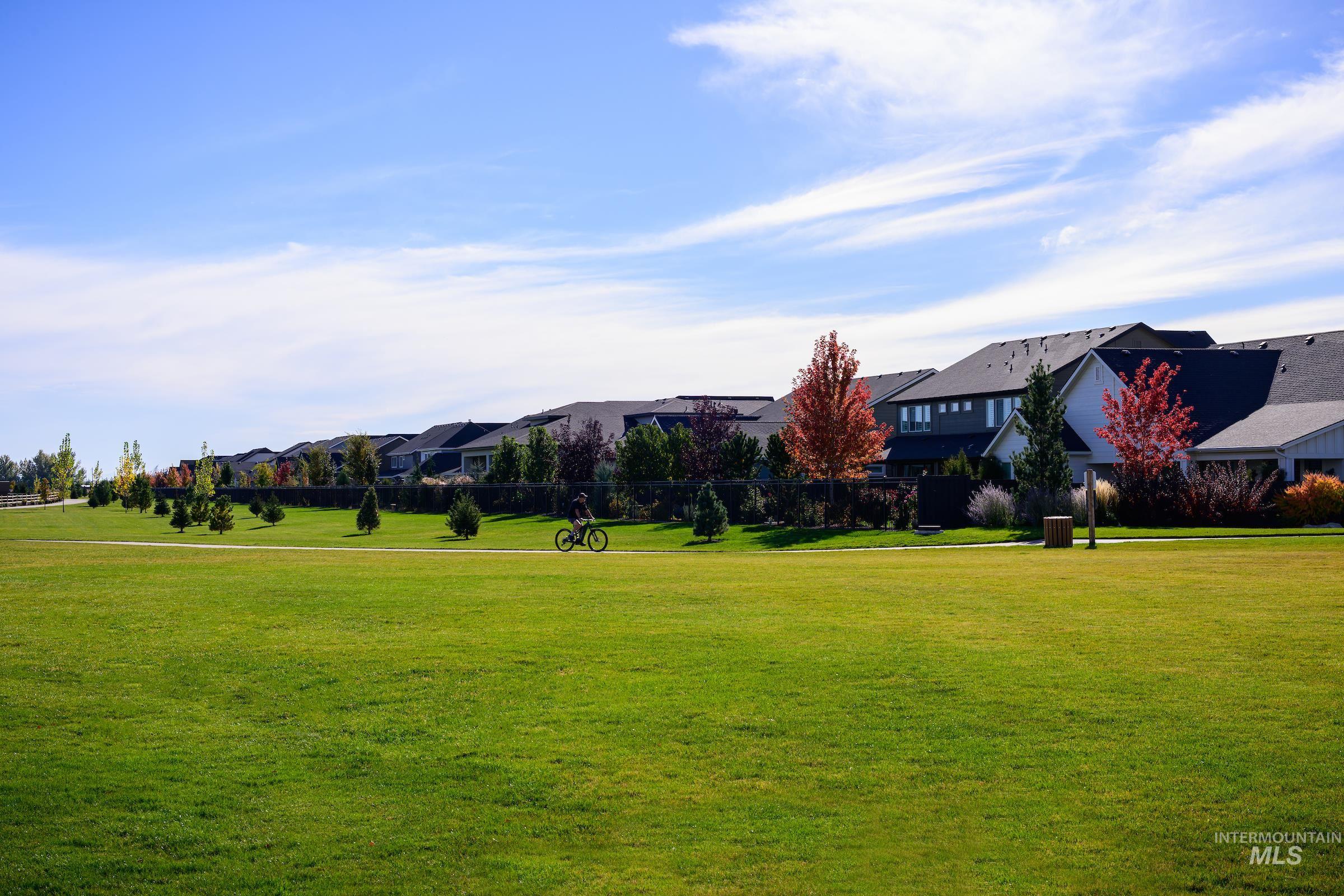 View of home's community with a residential view and a yard