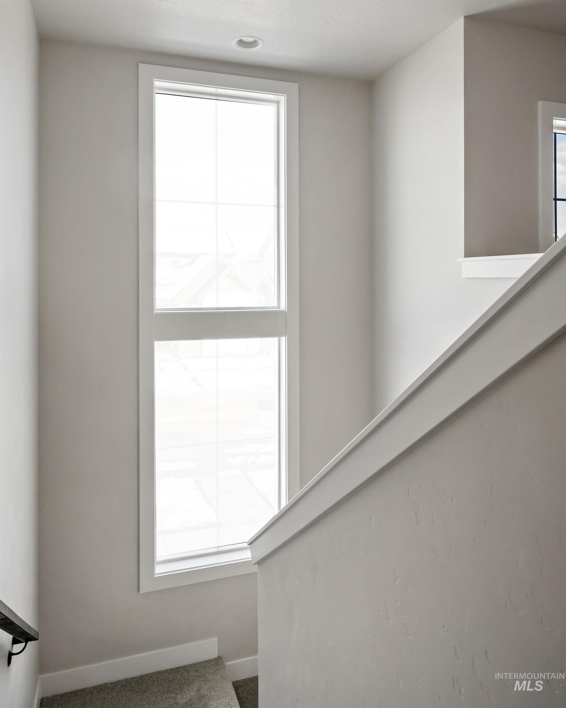 Staircase featuring baseboards