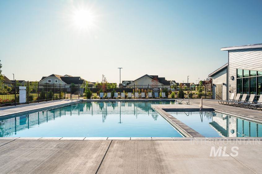 Community pool with a patio and a residential view