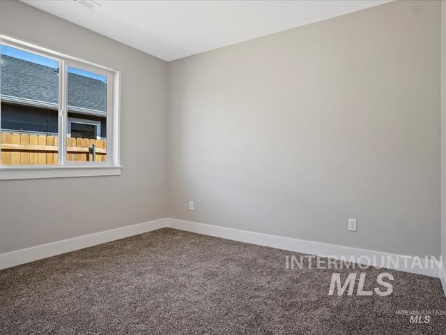 Unfurnished room with carpet