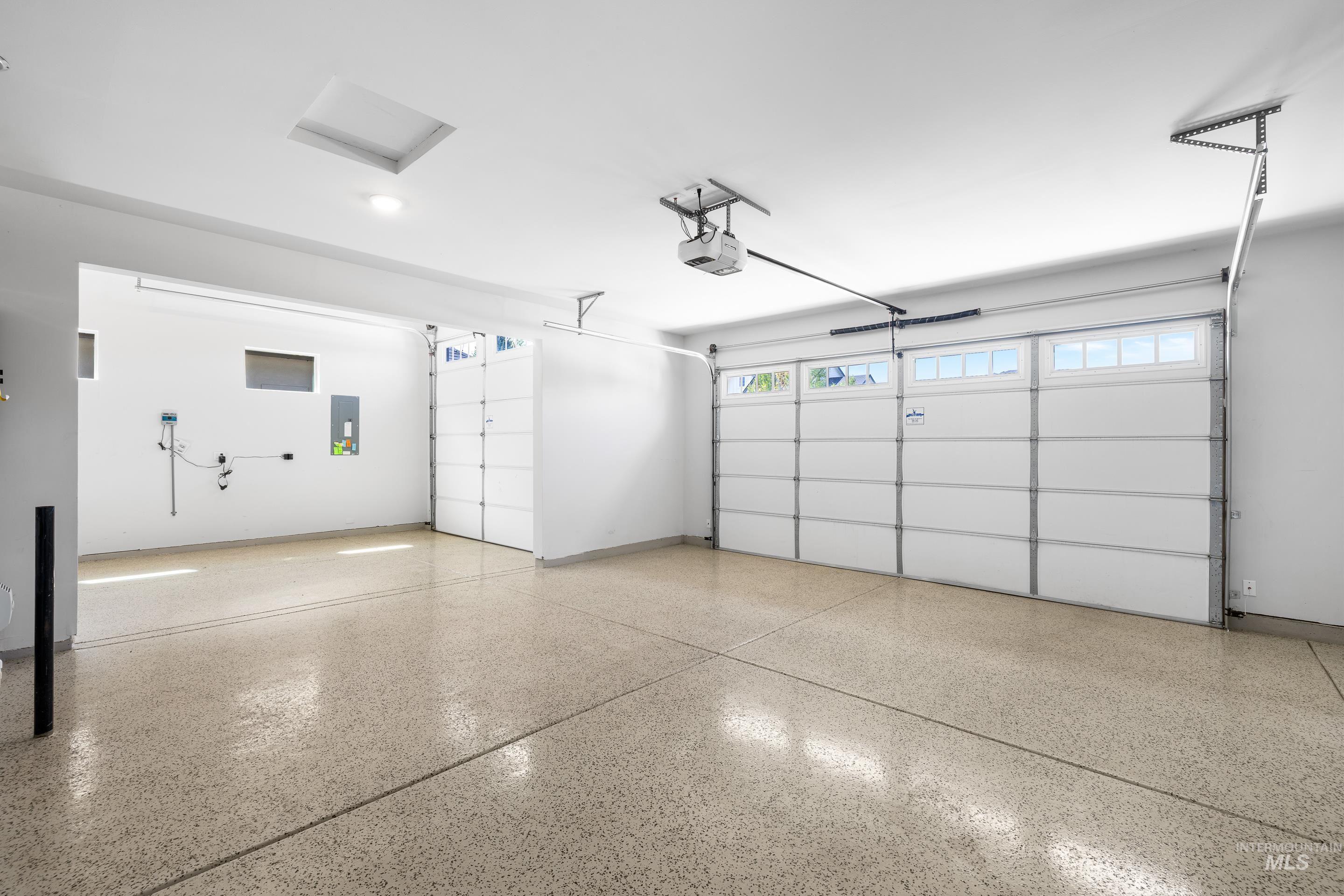 Garage with a garage door opener and electric panel