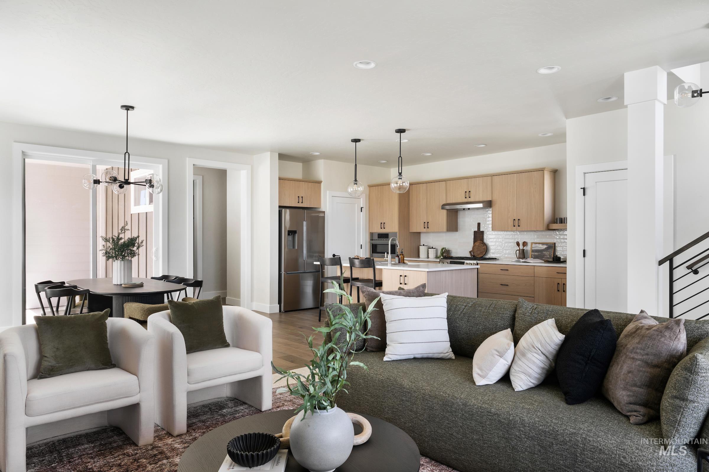 Living room with a chandelier, dark wood-type flooring, recessed lighting, and stairway