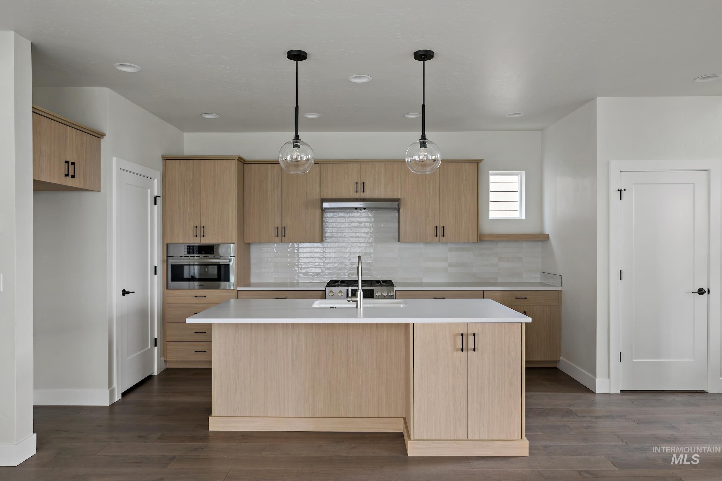 Kitchen featuring pendant lighting, stainless steel oven, backsplash, dark wood-style flooring, and recessed lighting