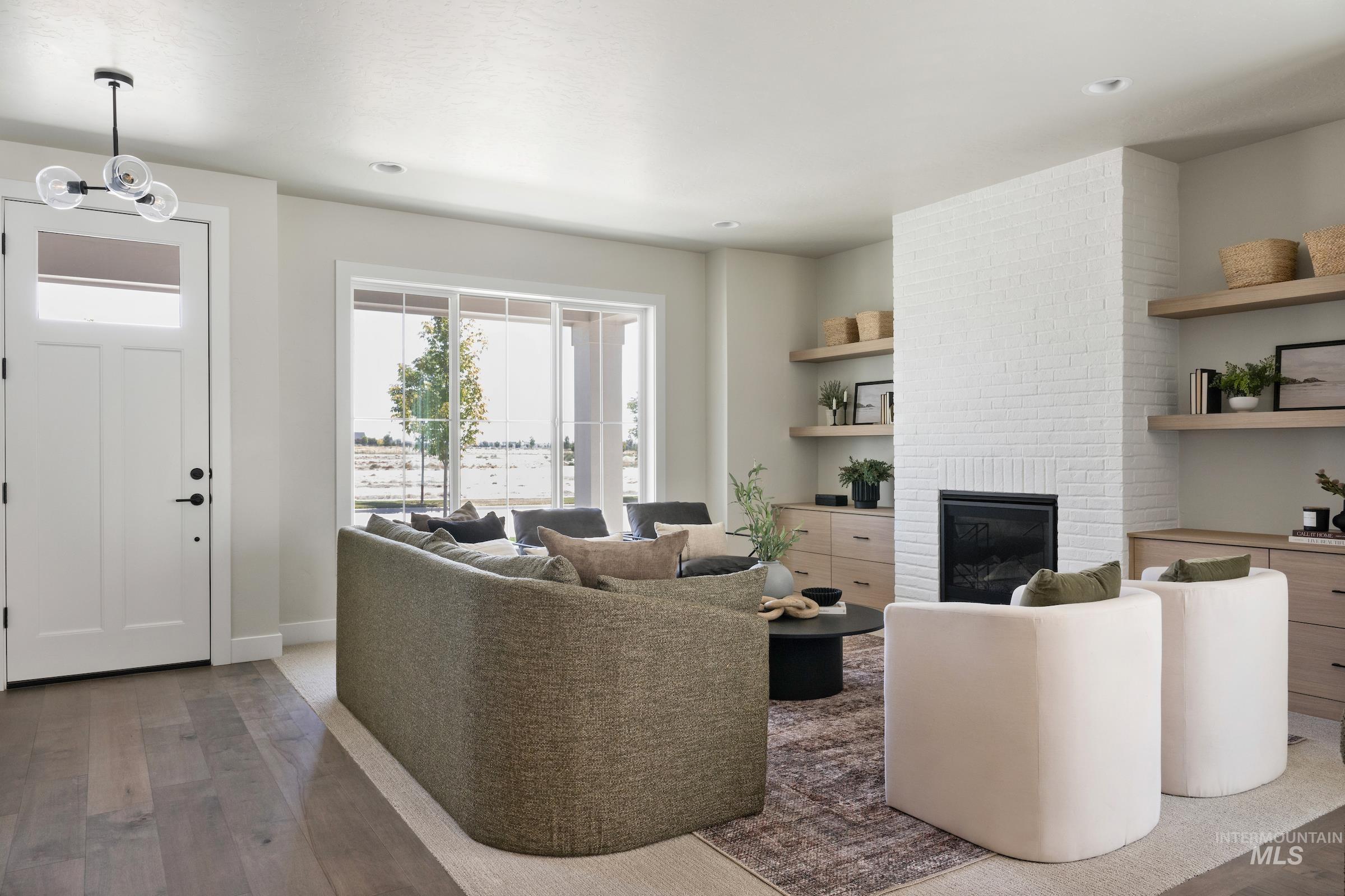 Living room featuring wood finished floors, a fireplace, and recessed lighting
