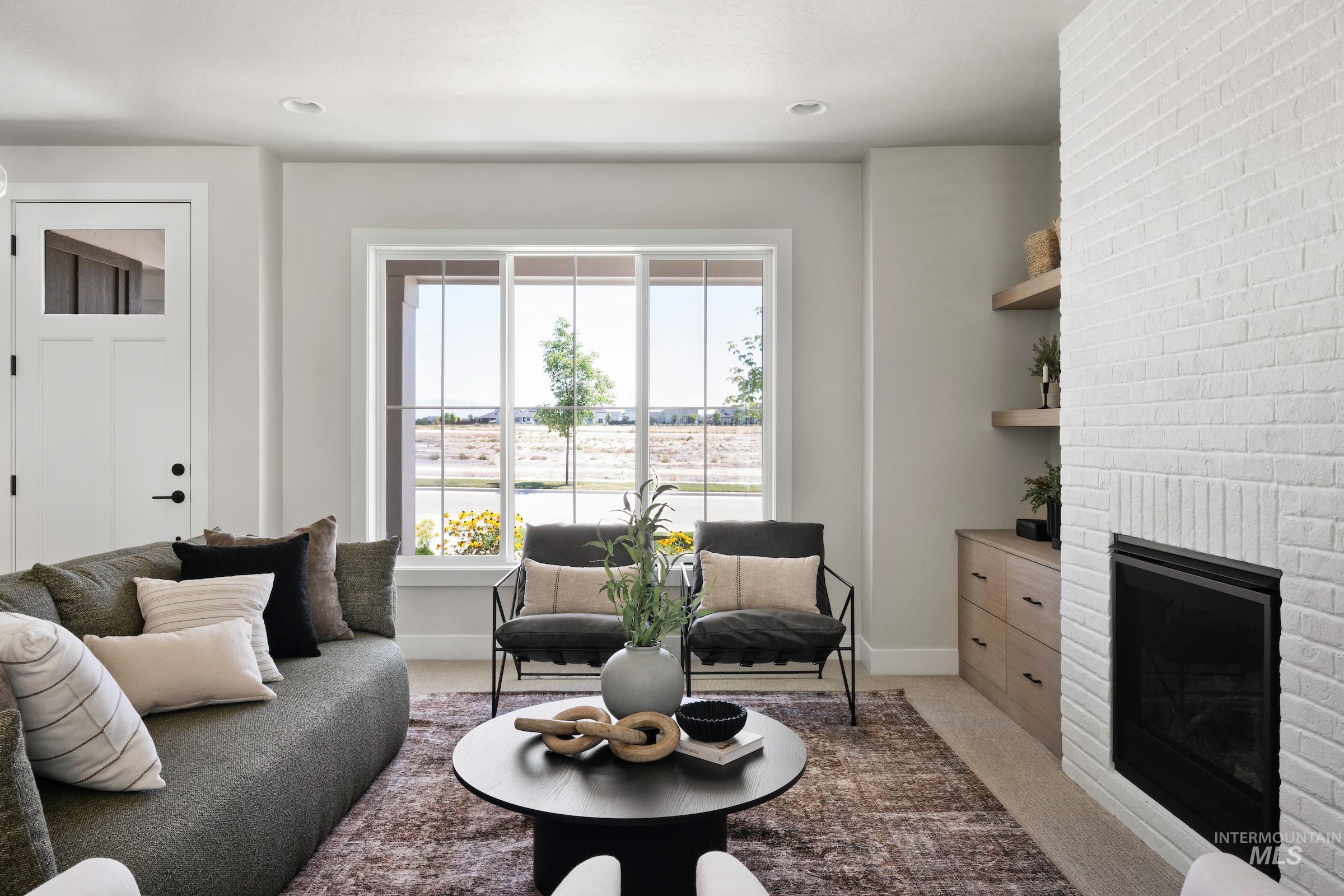 Living area featuring carpet flooring, a fireplace, and recessed lighting