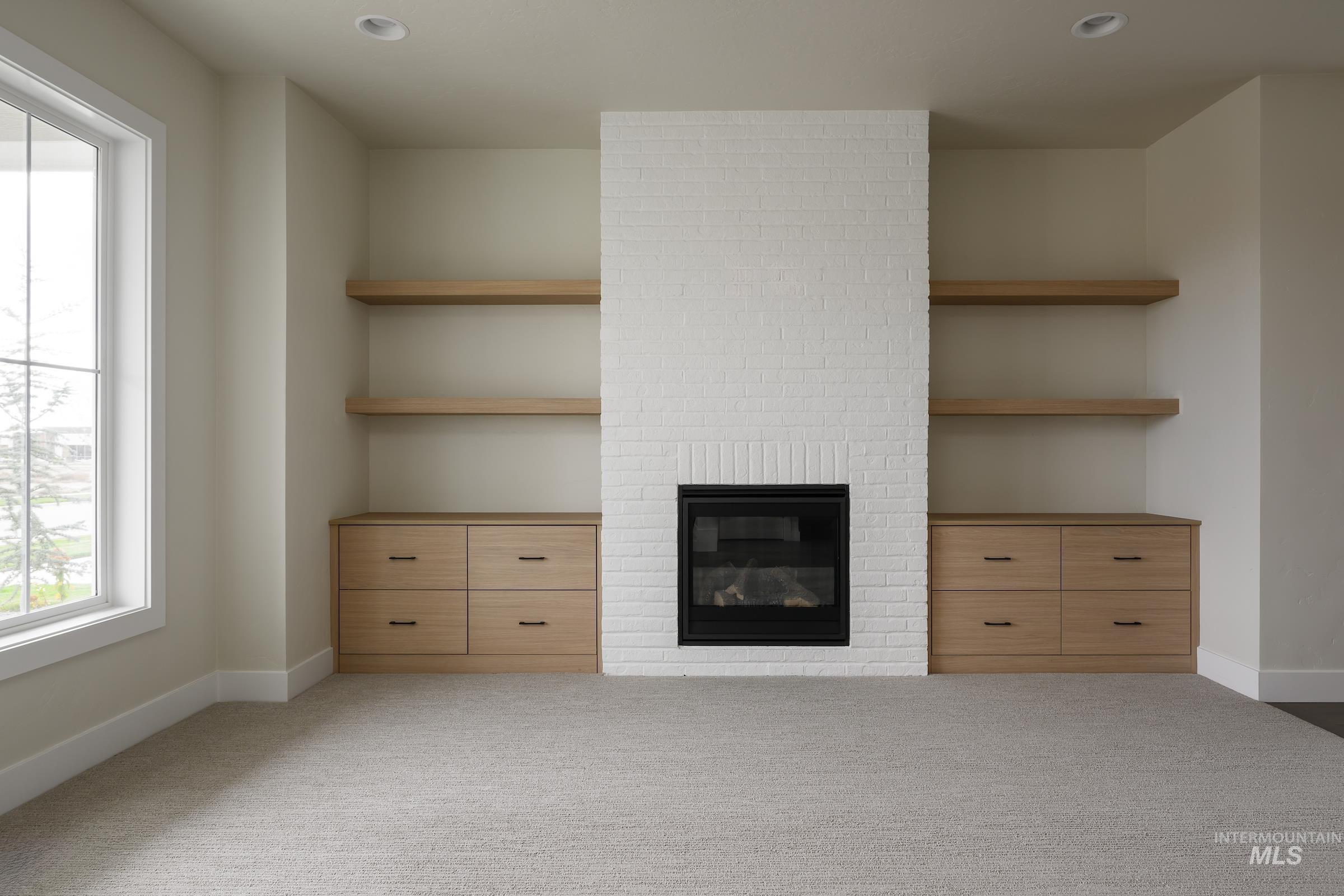 Unfurnished living room with a fireplace, light carpet, and recessed lighting