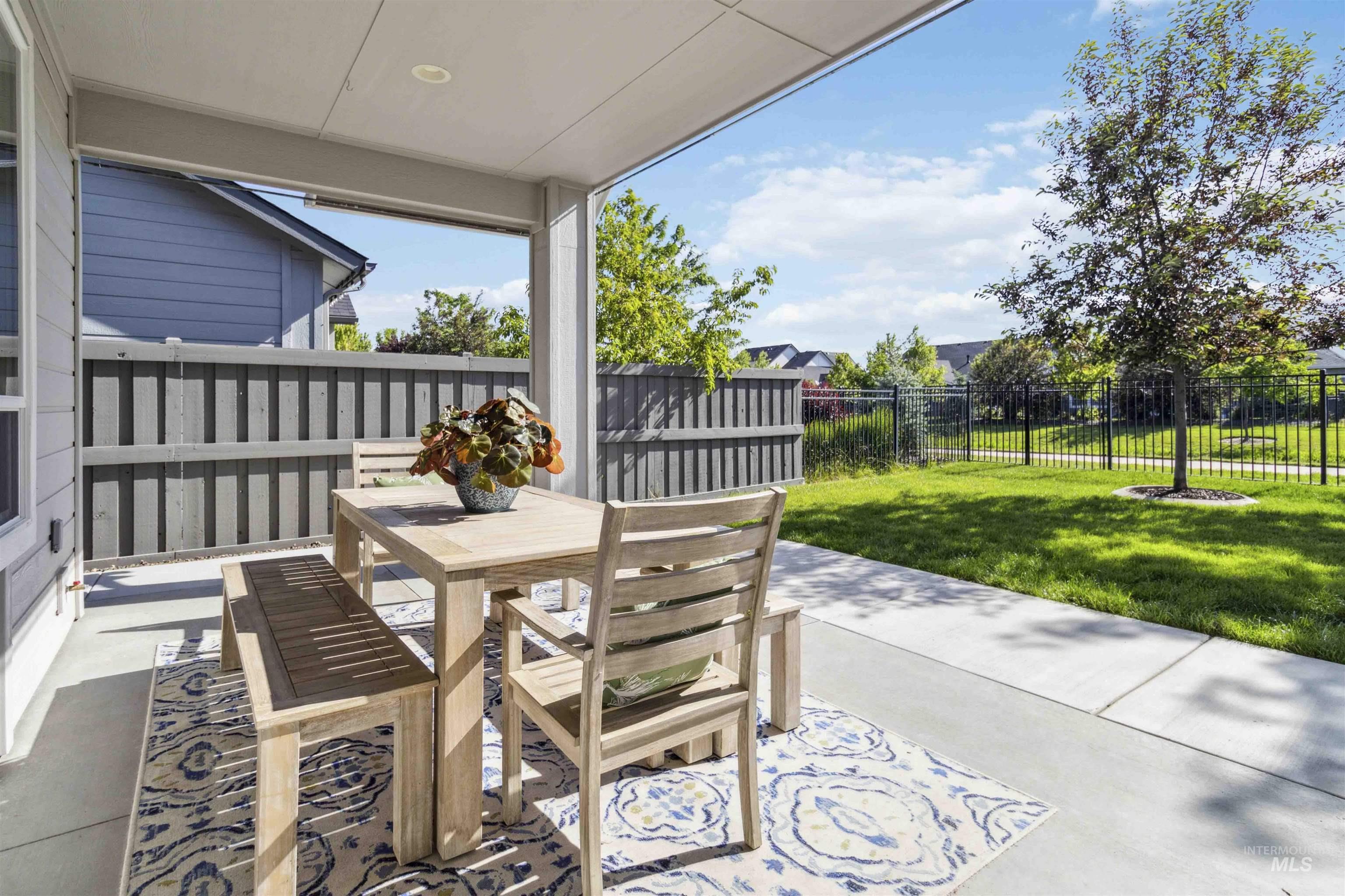 Fenced backyard with a patio and outdoor dining area