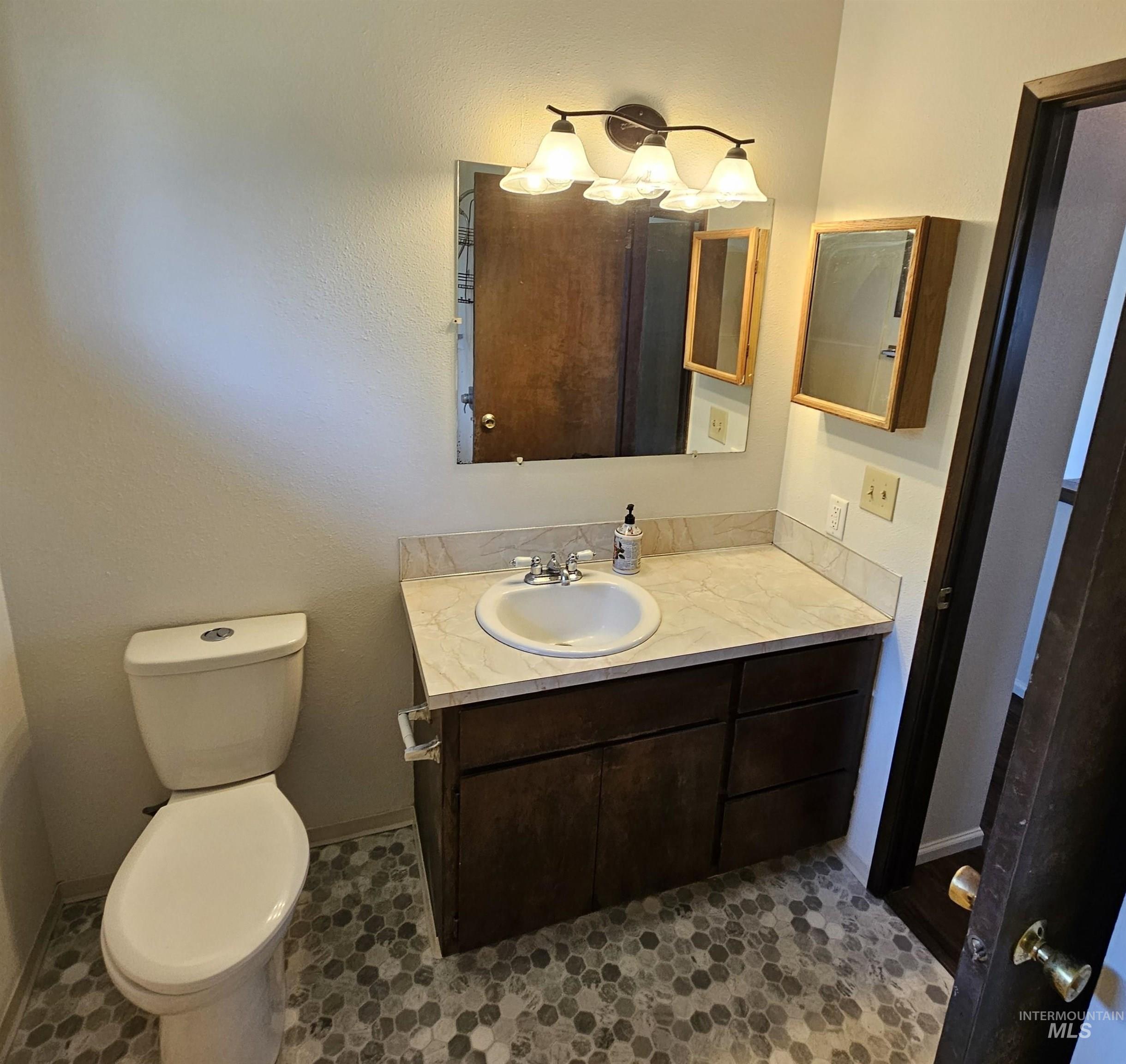 Half bath featuring vanity and toilet
